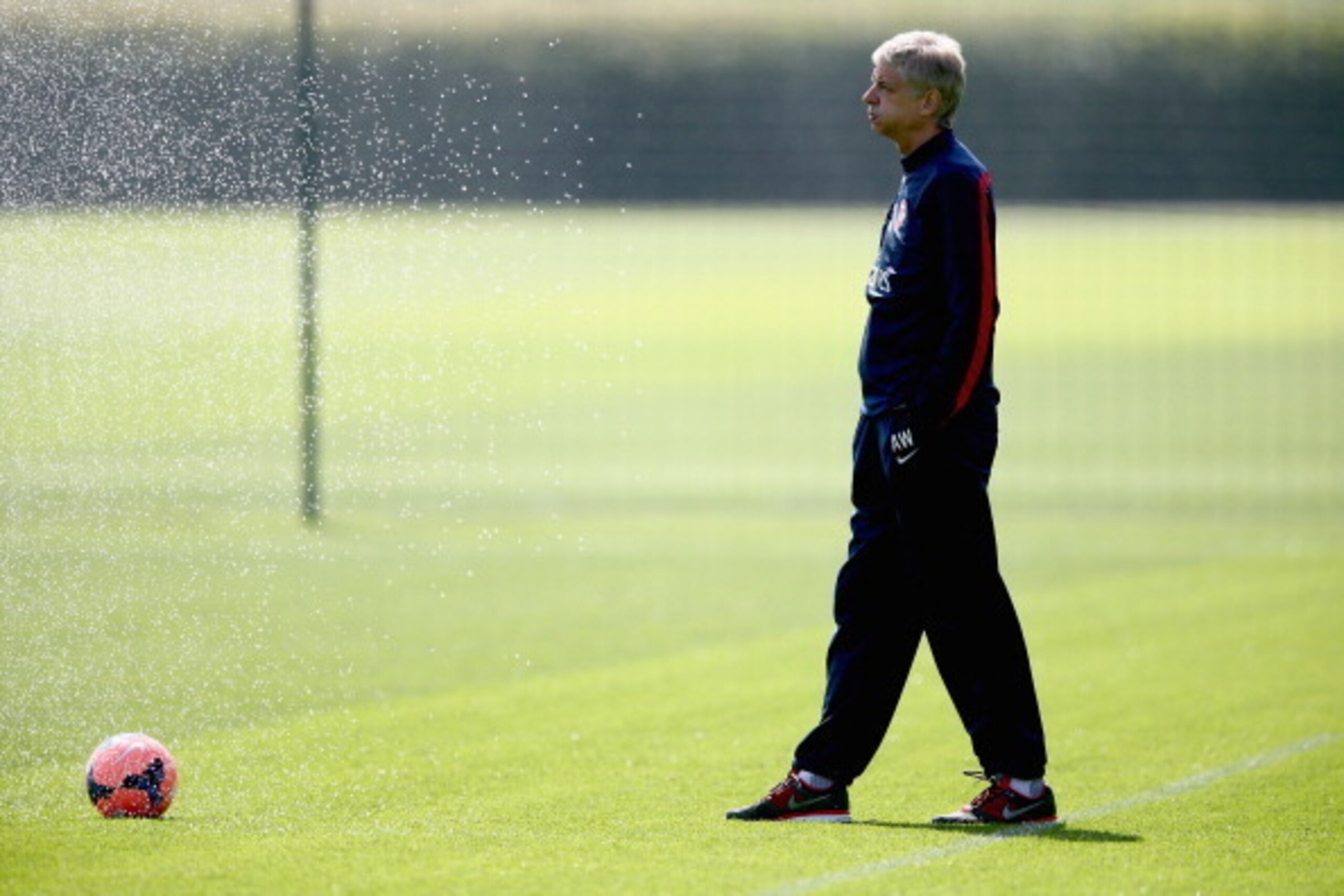 ST ALBANS, ENGLAND - MAY 14:  Arsene Wenger of Arsenal looks on during a training session ahead of the FA Cup Final match between Arsenal and Hull City at London Colney on May 14, 2014 in St Albans, England.  (Photo by Clive Mason/Getty Images)