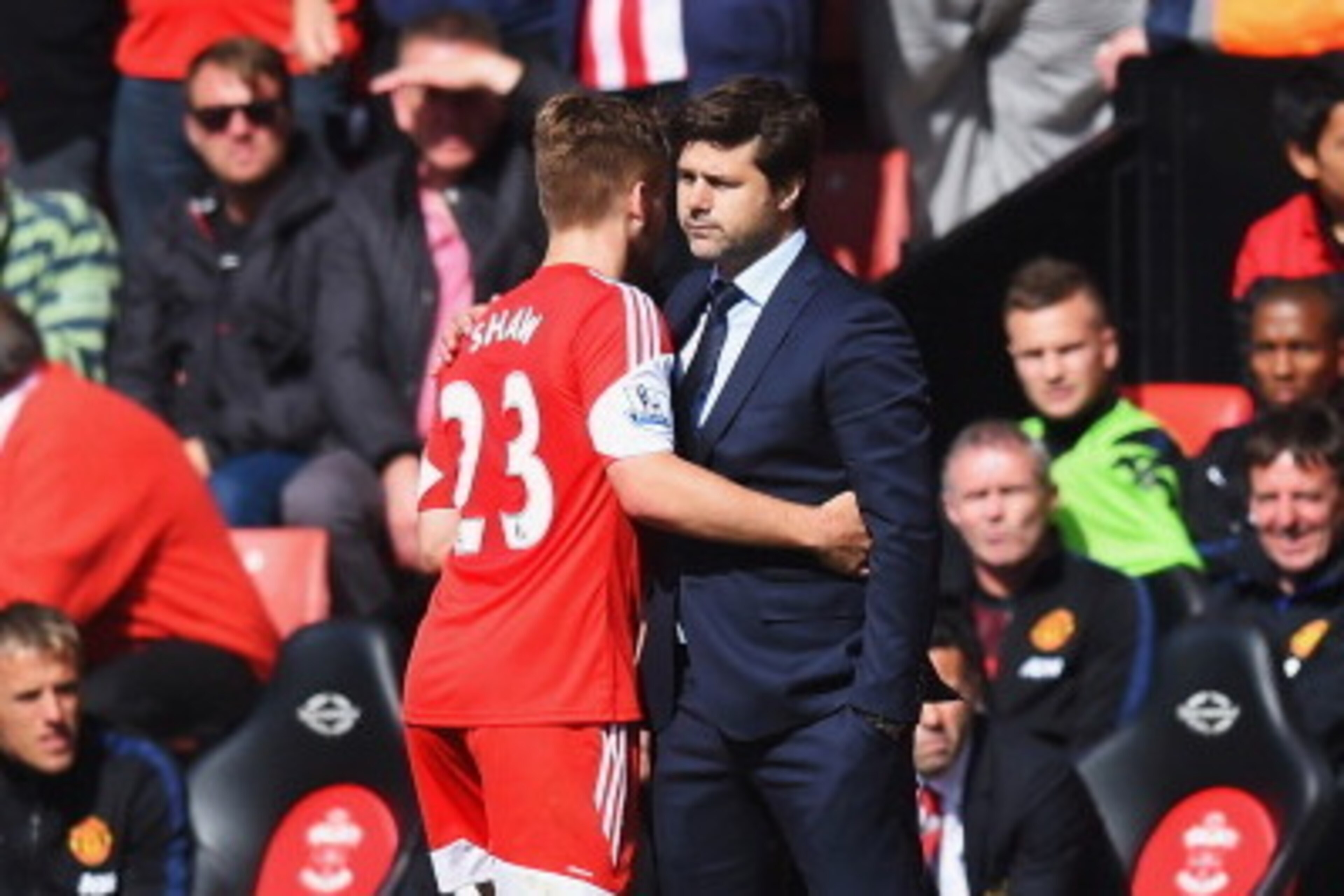 SOUTHAMPTON, ENGLAND - MAY 11:  Luke Shaw embraces his Southampton manager Mauricio Pochettino during the Barclays Premier League match between Southampton and Manchester United at St Mary's Stadium on May 11, 2014 in Southampton, England.  (Photo by Mike