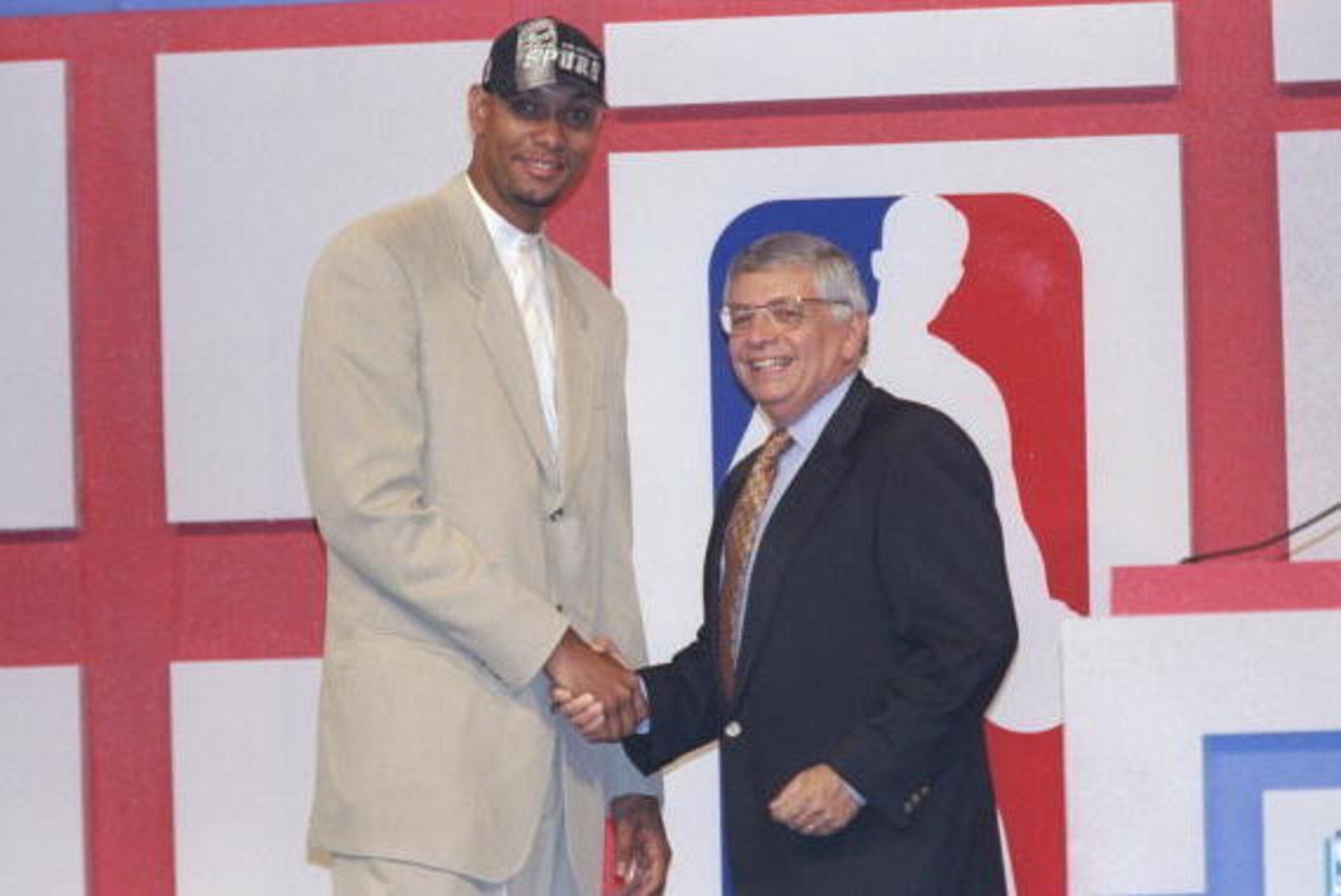 25 Jun 1997:  Center Tim Duncan of the San Antonio Spurs shakes hands with NBA Commissioner David Stern during the NBA Draft at the Charlotte Coliseum in Charlotte, North Carolina. Mandatory Credit: Craig Jones  /Allsport