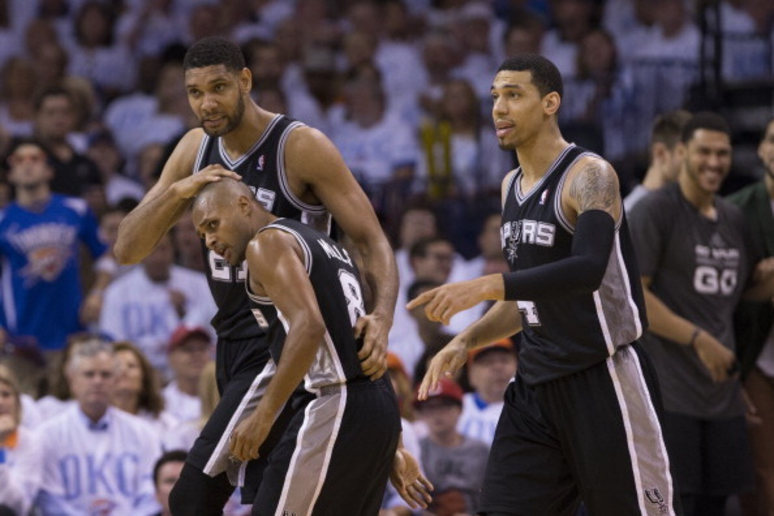 OKLAHOMA CITY, OK - May 31: Tim Duncan #21 of the San Antonio Spurs congratulates teammate Patty Mills #8 of the San Antonio Spurs during the game against the Oklahoma City Thunder in Game 6 of the Western Conference Finals during the 2014 NBA Playoffs a OKLAHOMA CITY, OK - May 31: Tim Duncan #21 of the San Antonio Spurs congratulates teammate Patty Mills #8 of the San Antonio Spurs during the game against the Oklahoma City Thunder in Game 6 of the Western Conference Finals during the 2014 NBA Playoffs a