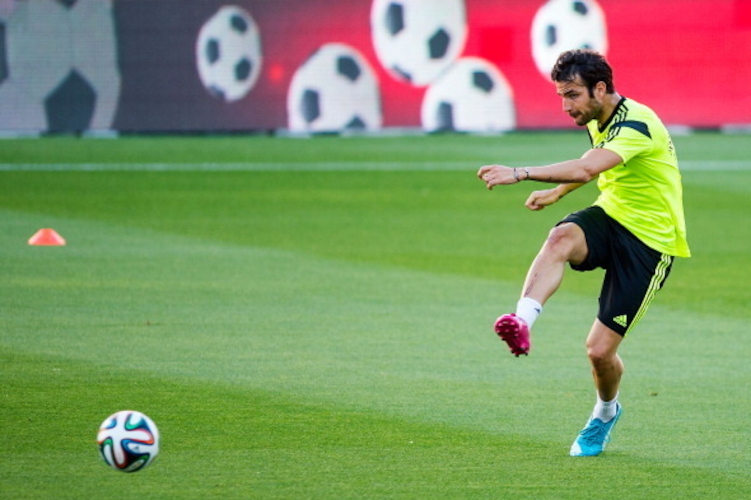 SEVILLE, SPAIN - MAY 29:  Cesc Fabregas of Spain shoots towards goal during a training session ahead of their international friendly match against Bolivia at the Ramon Sanchez Pizjuan stadium on May 29, 2014 in Seville, Spain.  (Photo by David Ramos/Getty
