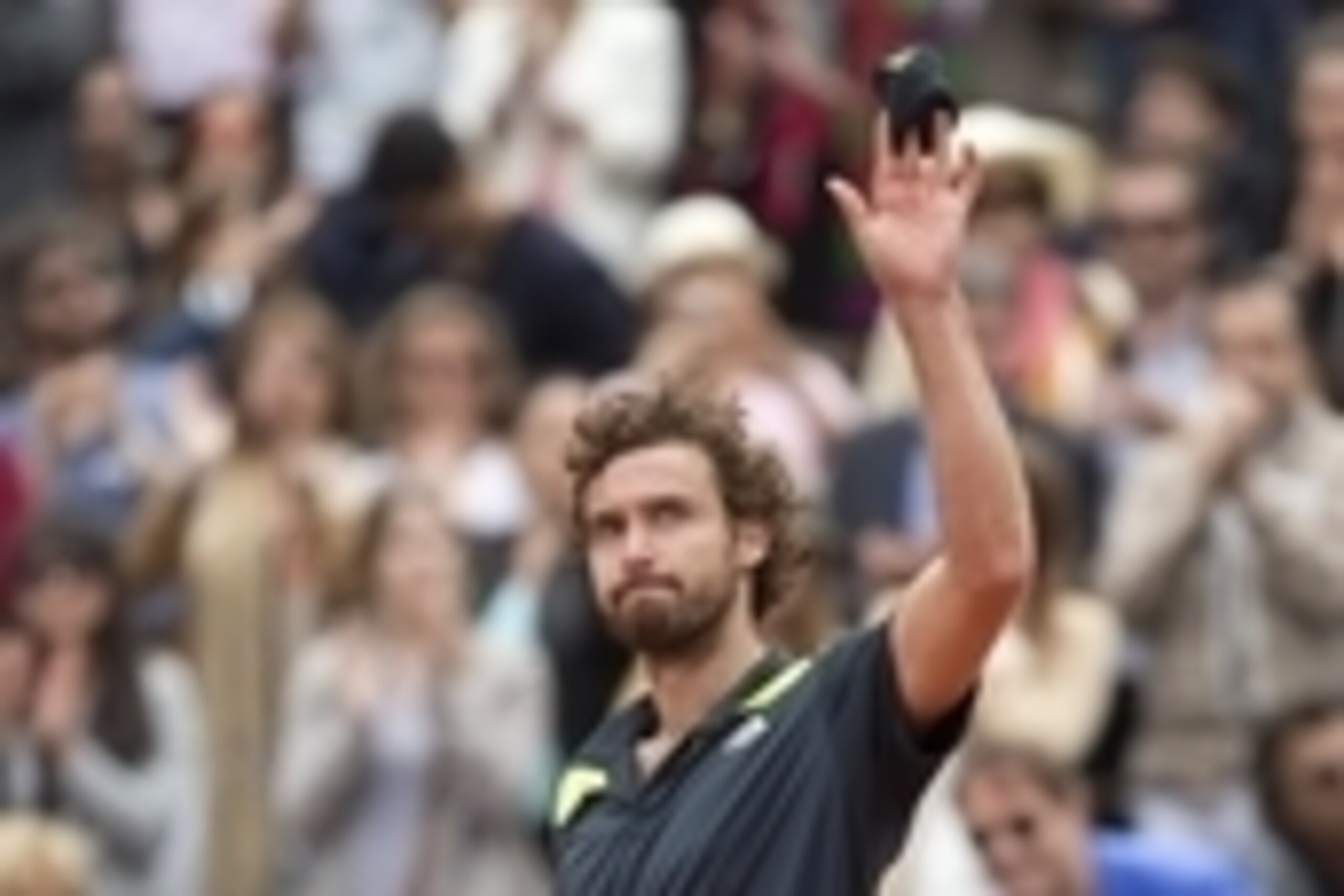 Jun 1, 2014; Paris, France;  Ernest Gulbis (LAT) celebrates recording match point during his match against Roger Federer (SUI) on day eight at the 2014 French Open at Roland Garros. Mandatory Credit: Susan Mullane-USA TODAY Sports