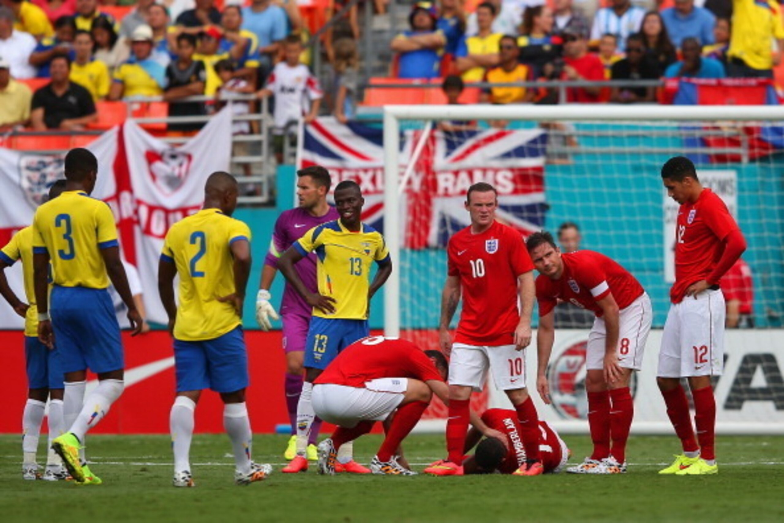 MIAMI GARDENS, FL - JUNE 04:  Frank Lampard and Rickie Lambert of England check on injured Alex Oxlade-Chamberlain of England as he goes lies on the pitch during the International friendly match between England and Ecuador at Sun Life Stadium on June 4, 2