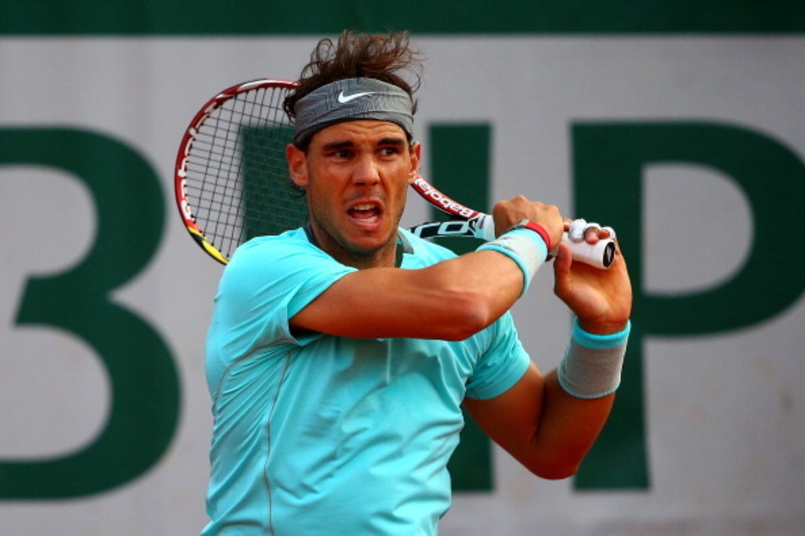 PARIS, FRANCE - JUNE 04:  Rafael Nadal of Spain returns a shot during his men's singles quarter-final match against David Ferrer of Spain on day eleven of the French Open at Roland Garros on June 4, 2014 in Paris, France.  (Photo by Dan Istitene/Getty Ima
