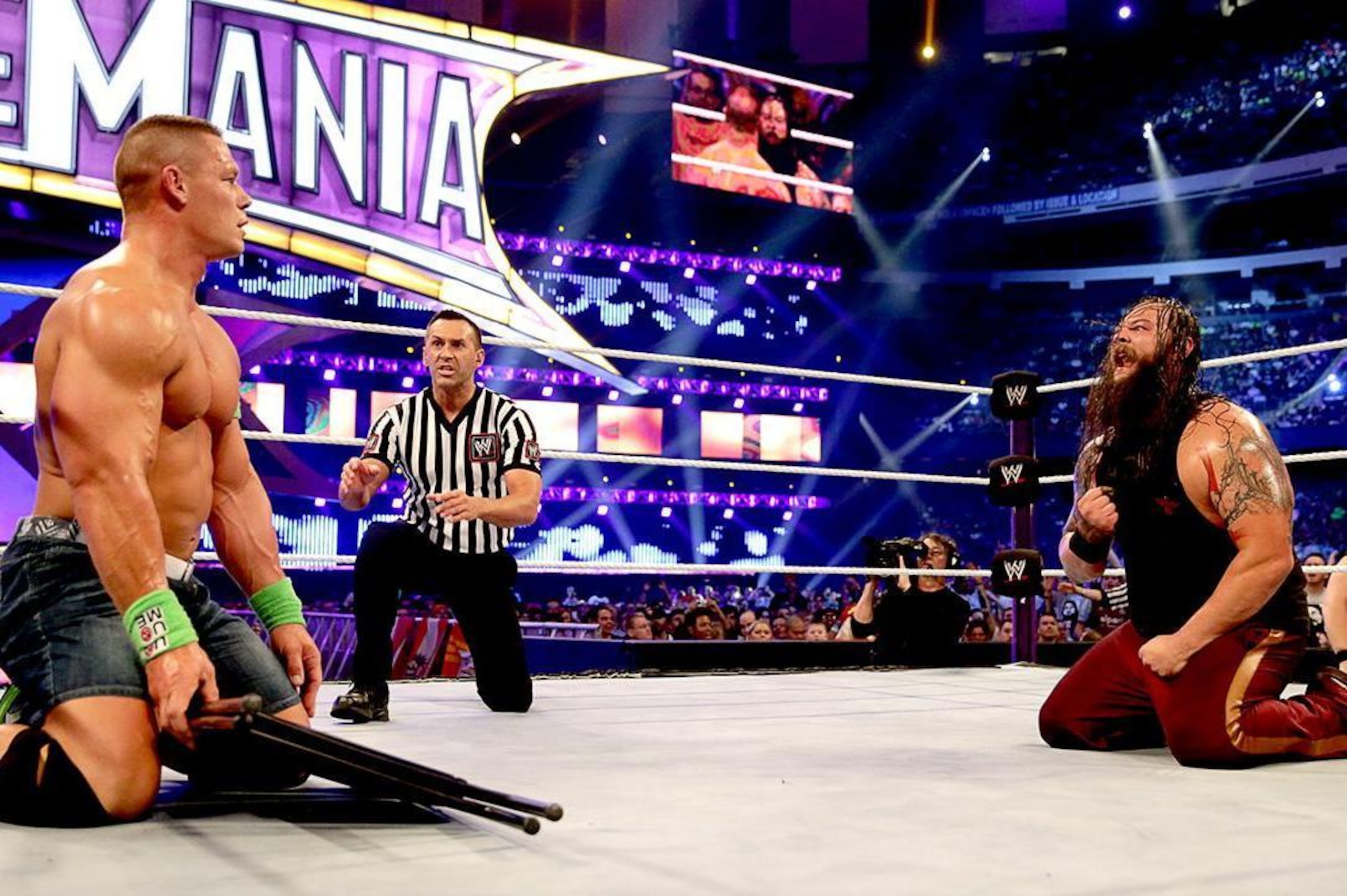 John Cena resists hitting Bray Wyatt with a chair.
