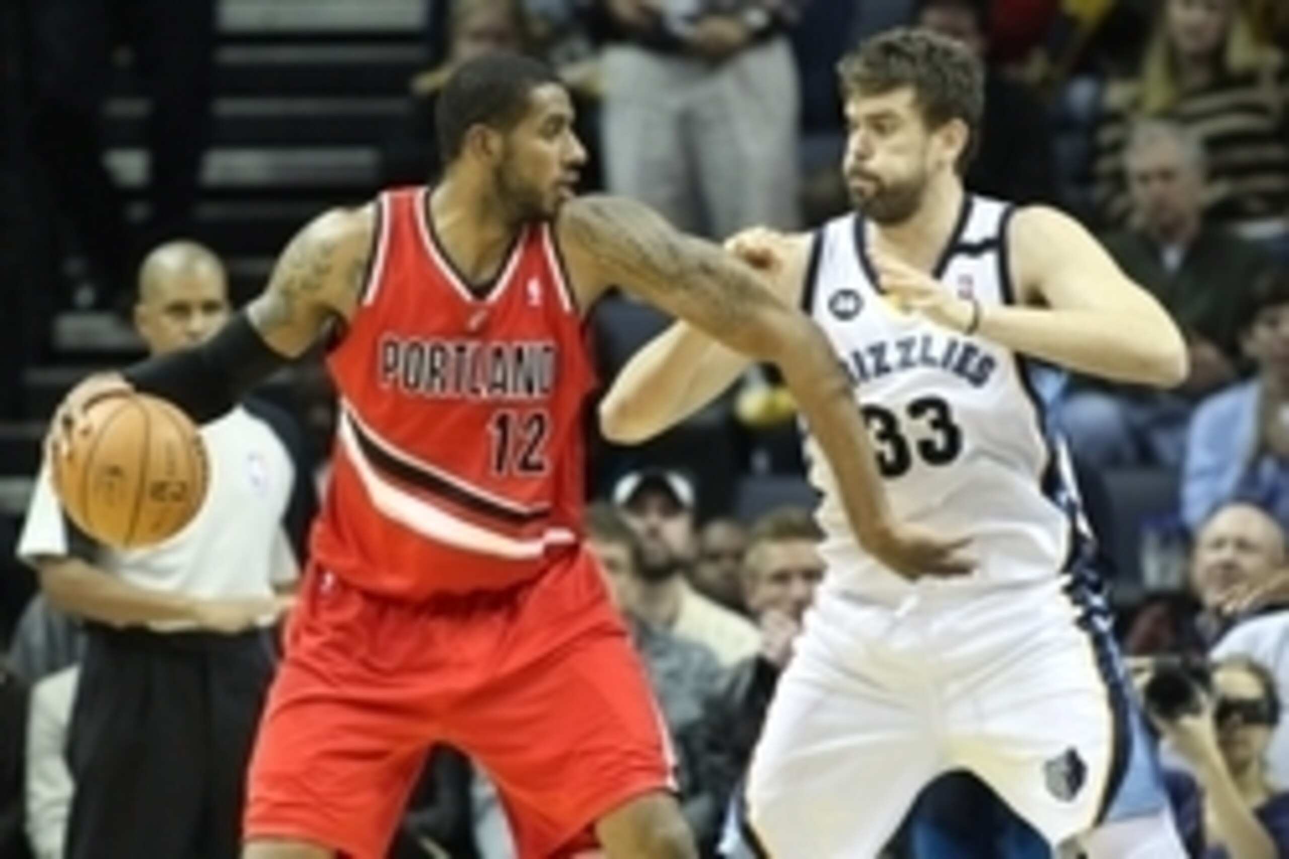 Jan 4, 2013; Memphis, TN, USA; Portland Trail Blazers forward LaMarcus Aldridge (12) drives against Memphis Grizzlies center Marc Gasol (33) at the FedEx Forum. Portland defeated Memphis 86-84. Mandatory Credit: Nelson Chenault-USA TODAY Sports