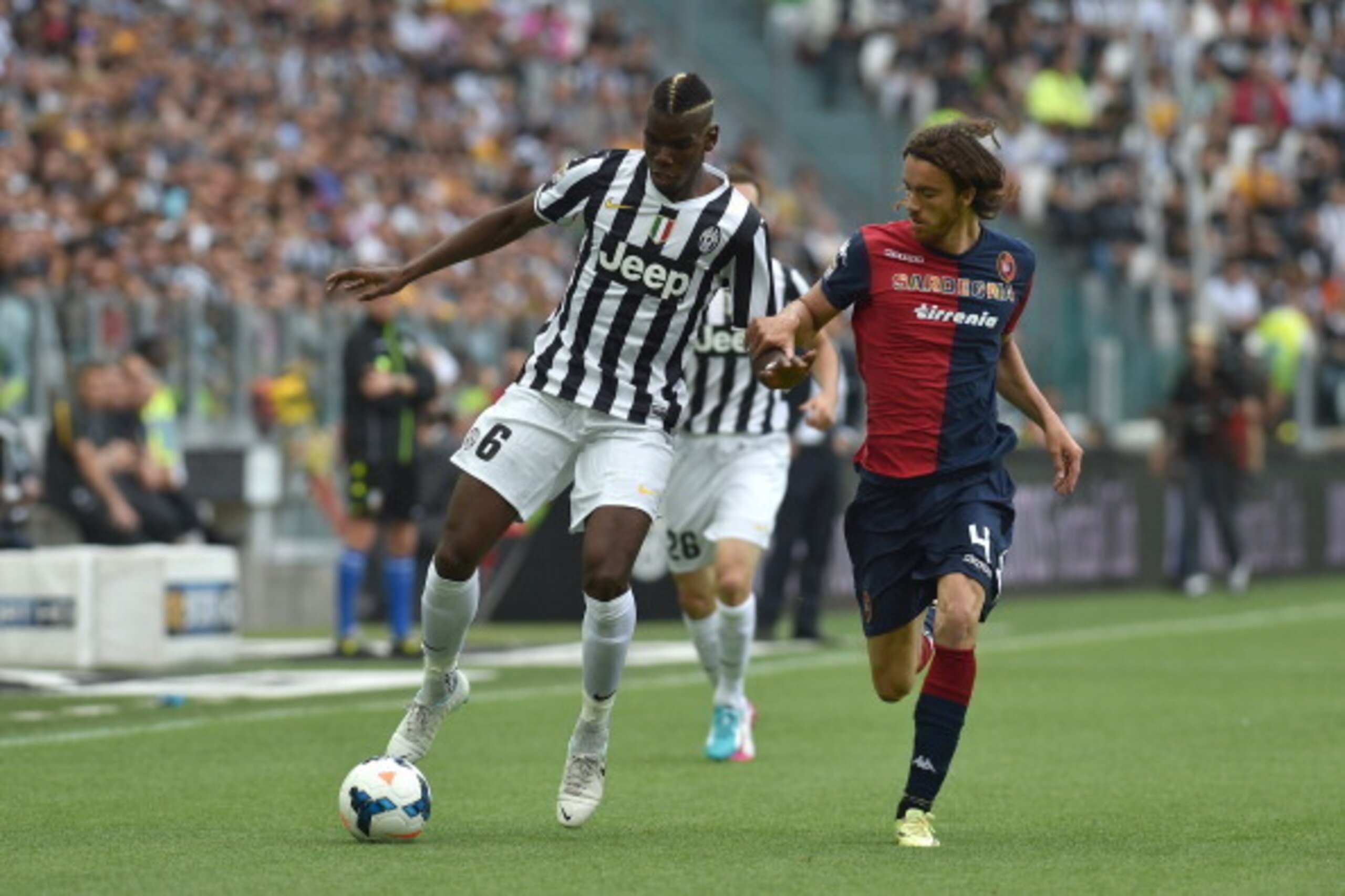 TURIN, ITALY - MAY 18:  Paul Pogba (L) of Juventus is challenged by Andrea Tabanelli of Cagliari Calcio during the Serie A match between Juventus and Cagliari Calcio at Juventus Arena on May 18, 2014 in Turin, Italy.  (Photo by Valerio Pennicino/Getty Ima