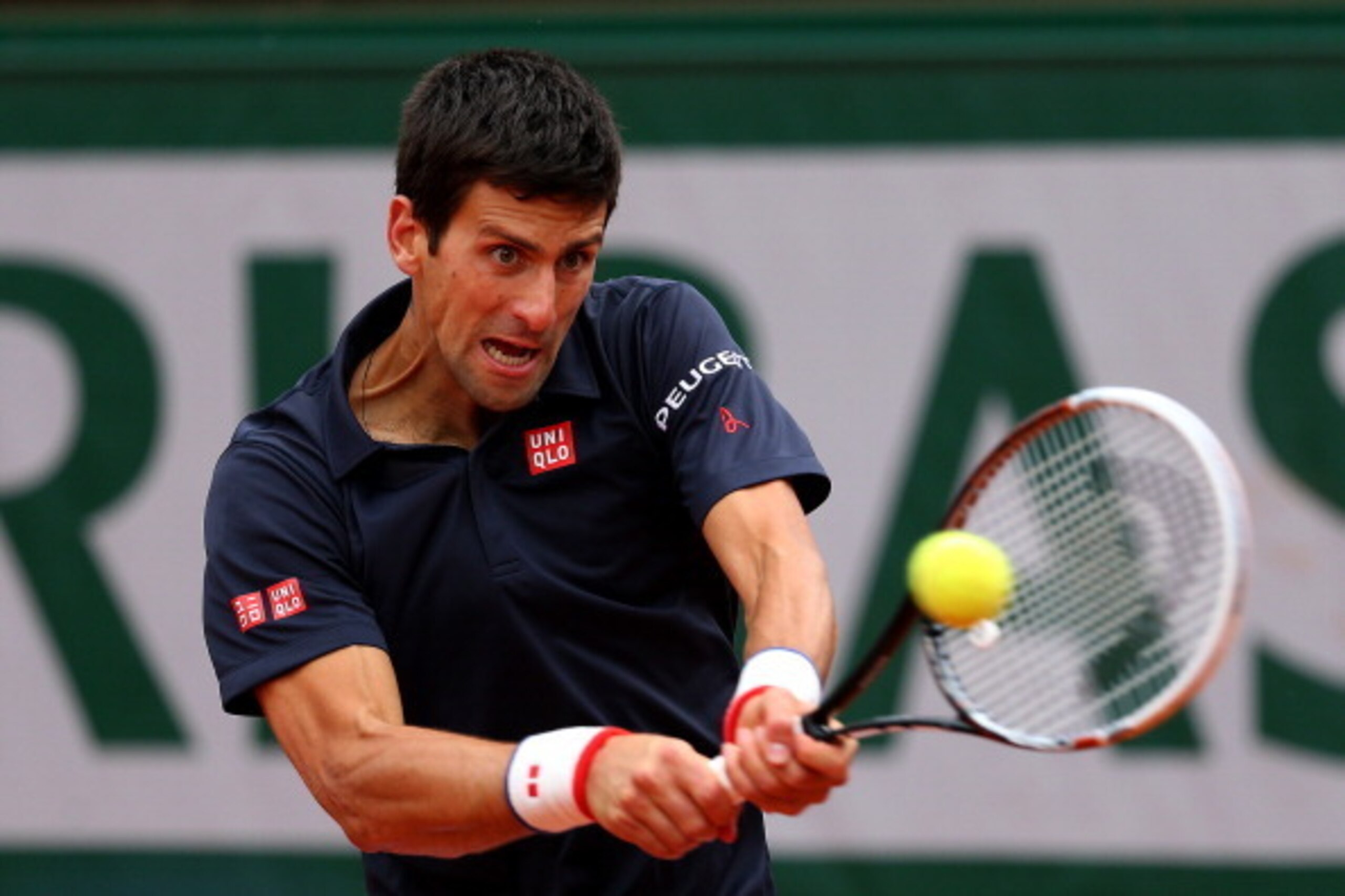 PARIS, FRANCE - JUNE 03:  Novak Djokovic of Serbia returns a shot during his men's singles match against Milos Raonic of Canada on day ten of the French Open at Roland Garros on June 3, 2014 in Paris, France.  (Photo by Clive Brunskill/Getty Images)