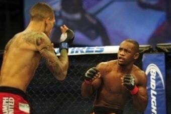 Nov 6, 2013; Fort Campbell, KY, USA; Yves Edwards (red gloves) fights Yancy Medeiros (blue gloves) in the lightweight bout during UFC Fight for the Troops at Fort Campbell. Mandatory Credit: Joshua Lindsey-USA TODAY Sports