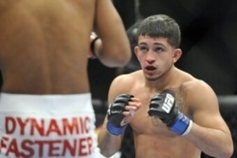 Jan 25, 2014; Chicago, IL, USA; Alex Caceres (red gloves) fights Sergio Pettis (blue gloves) during UFC on FOX 10 at the United Center. Mandatory Credit: David Banks-USA TODAY Sports