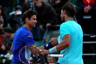 PARIS, FRANCE - JUNE 04:  Rafael Nadal of Spain shakes hands with David Ferrer of Spain at the net after their men's singles quarter-final match on day eleven of the French Open at Roland Garros on June 4, 2014 in Paris, France.  (Photo by Dan Istitene/Ge