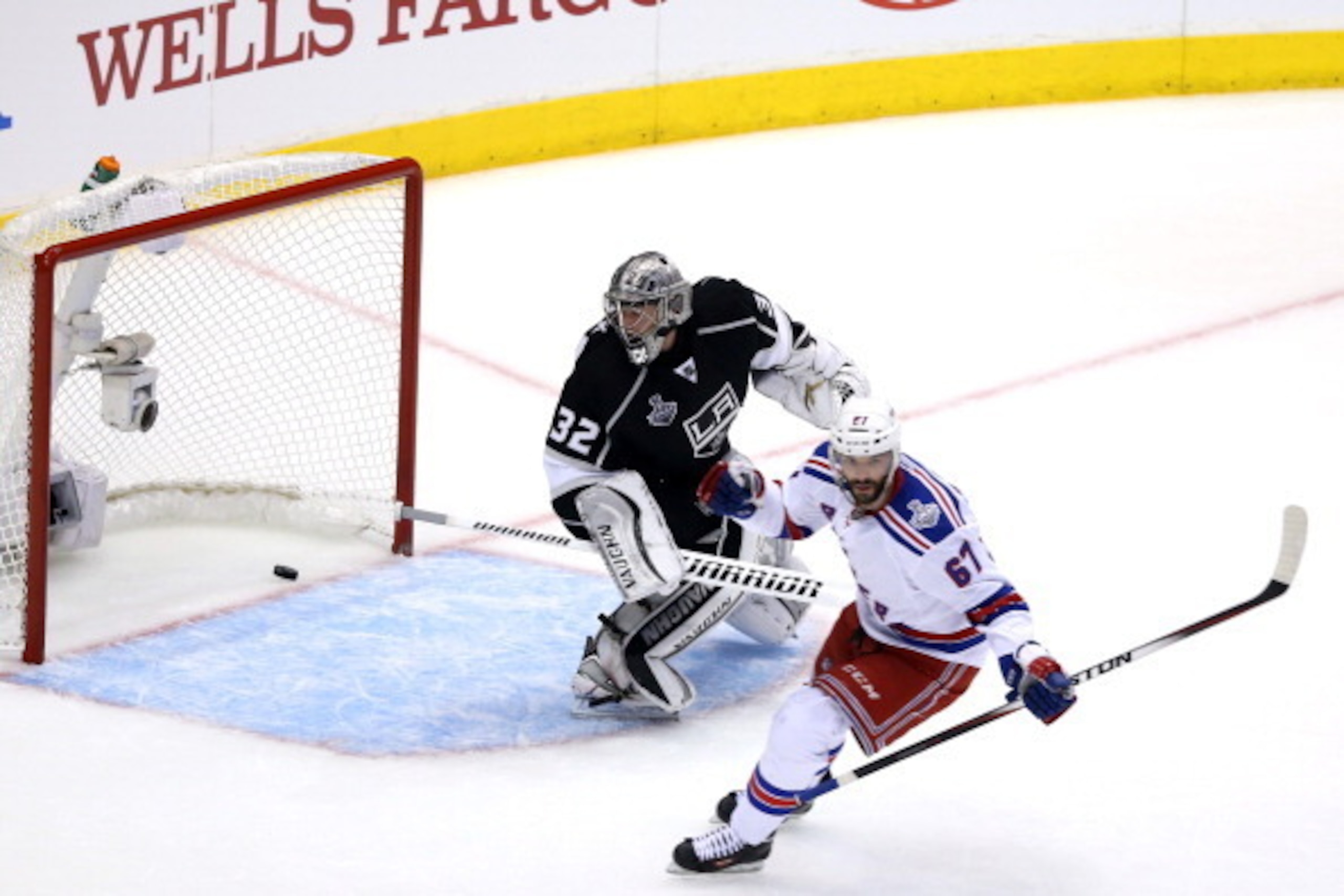 LOS ANGELES, CA - JUNE 04:  Benoit Pouliot #67 of the New York Rangers scores a first period goal against goaltender Jonathan Quick #32 of the Los Angeles Kings in the first period during Game One of the 2014 NHL Stanley Cup Final at the Staples Center on