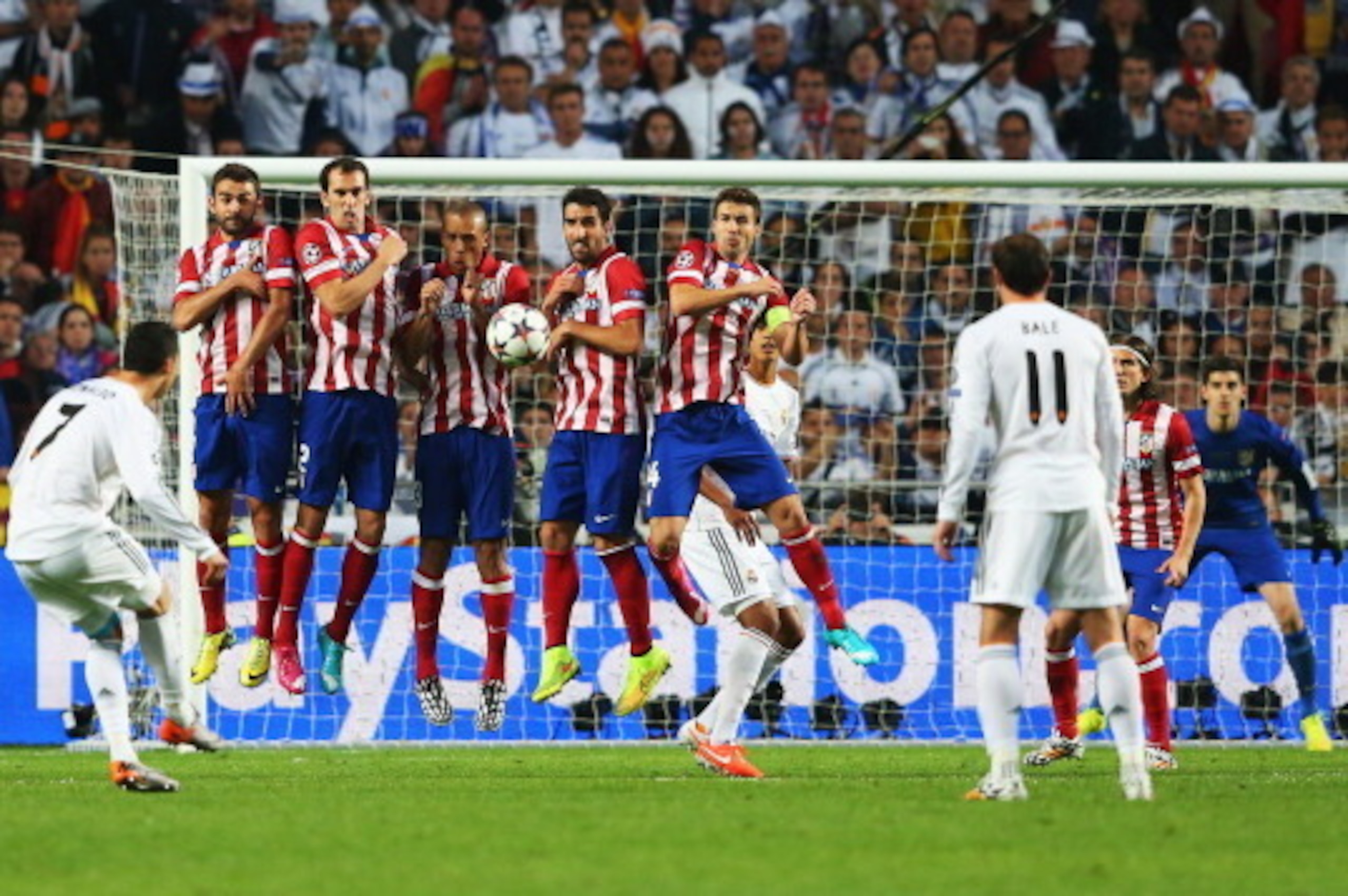 LISBON, PORTUGAL - MAY 24:  Cristiano Ronaldo of Real Madrid (7) shoots from a free kick during the UEFA Champions League Final between Real Madrid and Atletico de Madrid at Estadio da Luz on May 24, 2014 in Lisbon, Portugal.  (Photo by Alex Livesey/Getty