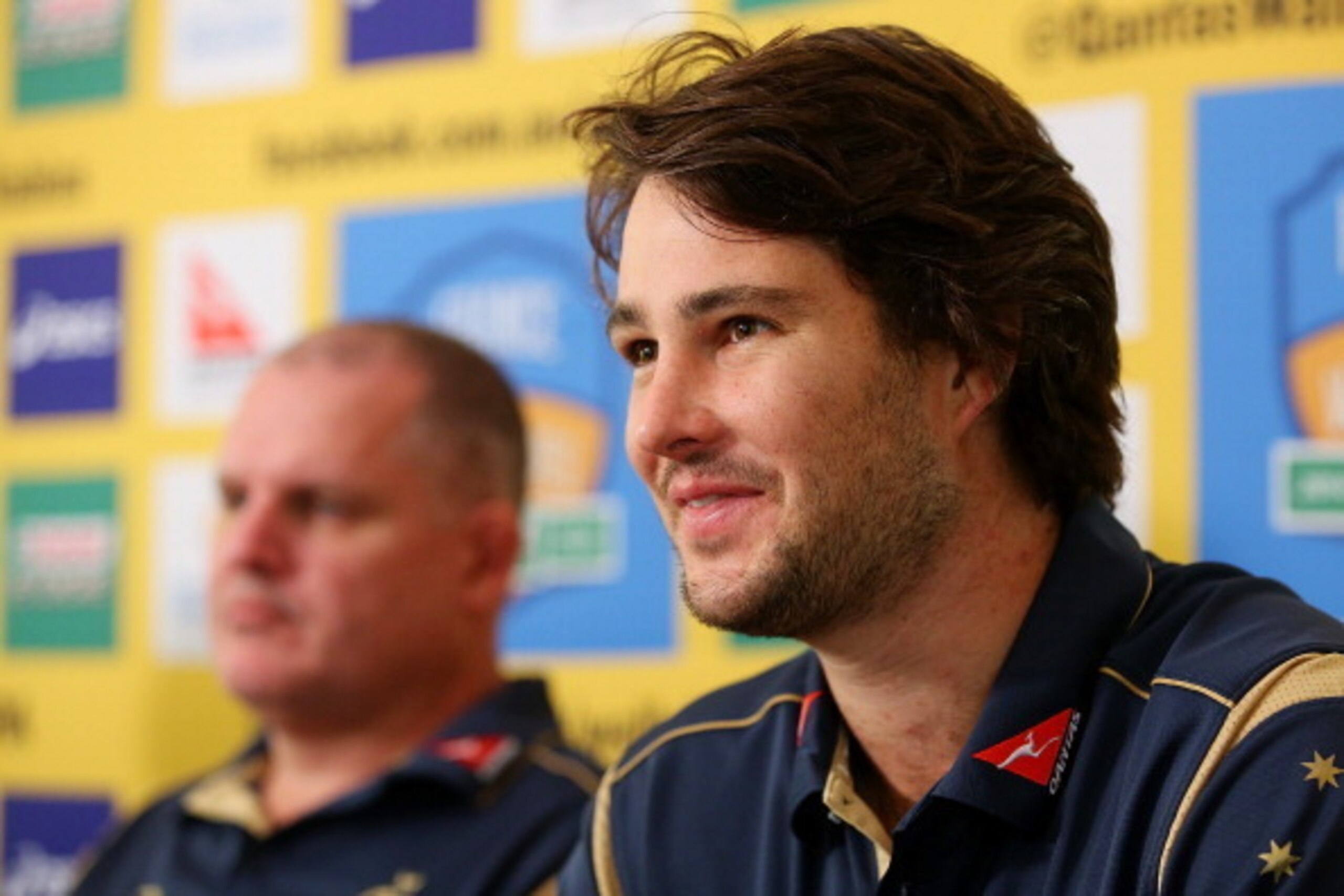 GOLD COAST, AUSTRALIA - JUNE 03:  Sam Carter speaks to media while Coach Ewen McKenzie looks on during an Australian Wallabies team announcement at Sanctuary Cove on June 3, 2014 in Gold Coast, Australia.  (Photo by Chris Hyde/Getty Images)