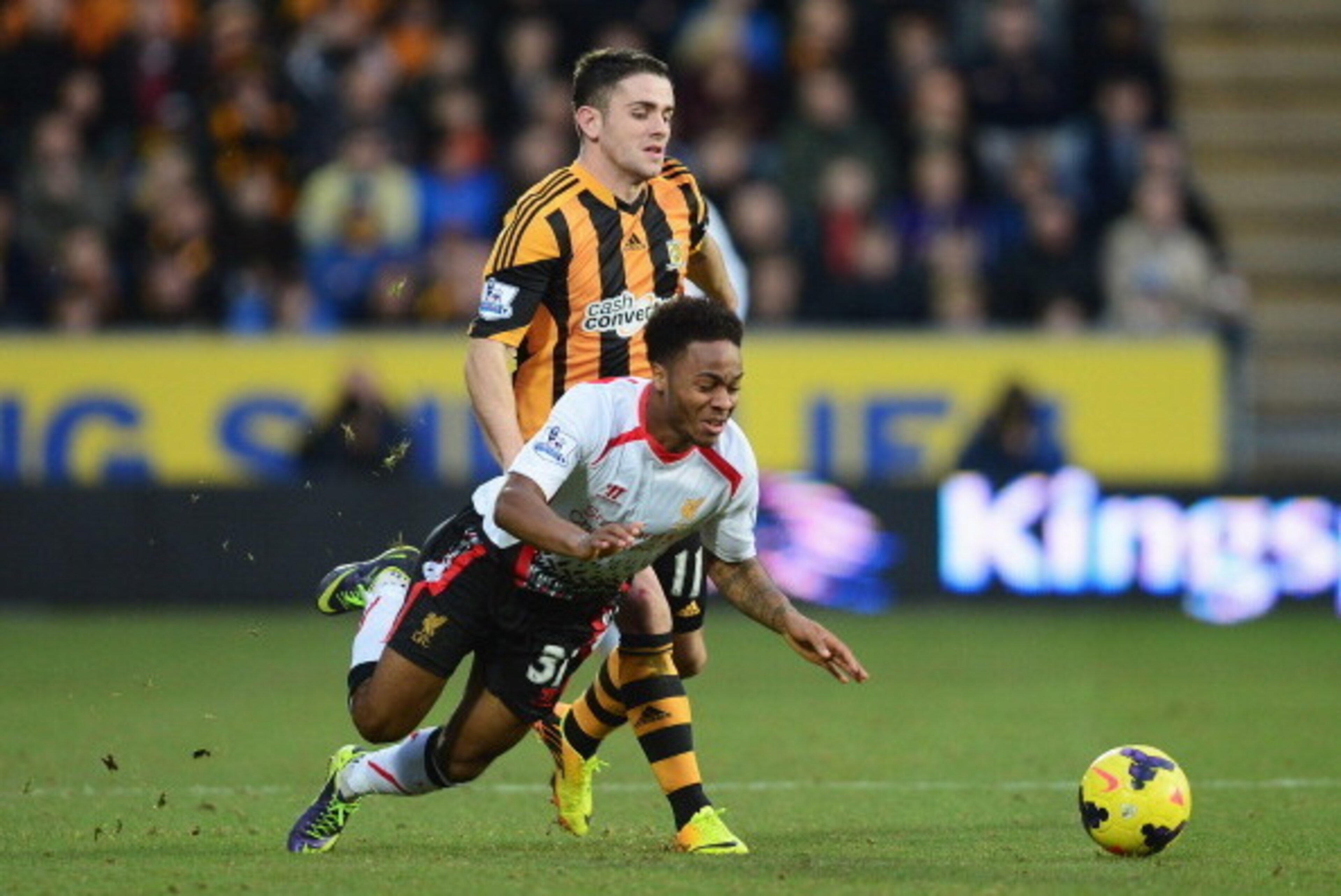 HULL, ENGLAND - DECEMBER 01:  Raheem Sterling of Liverpool goes to ground under a challenge from Robbie Brady of Hull City during the Barclays Premier League match between Hull City and Liverpool at KC Stadium on December 1, 2013 in Hull, England.  (Photo