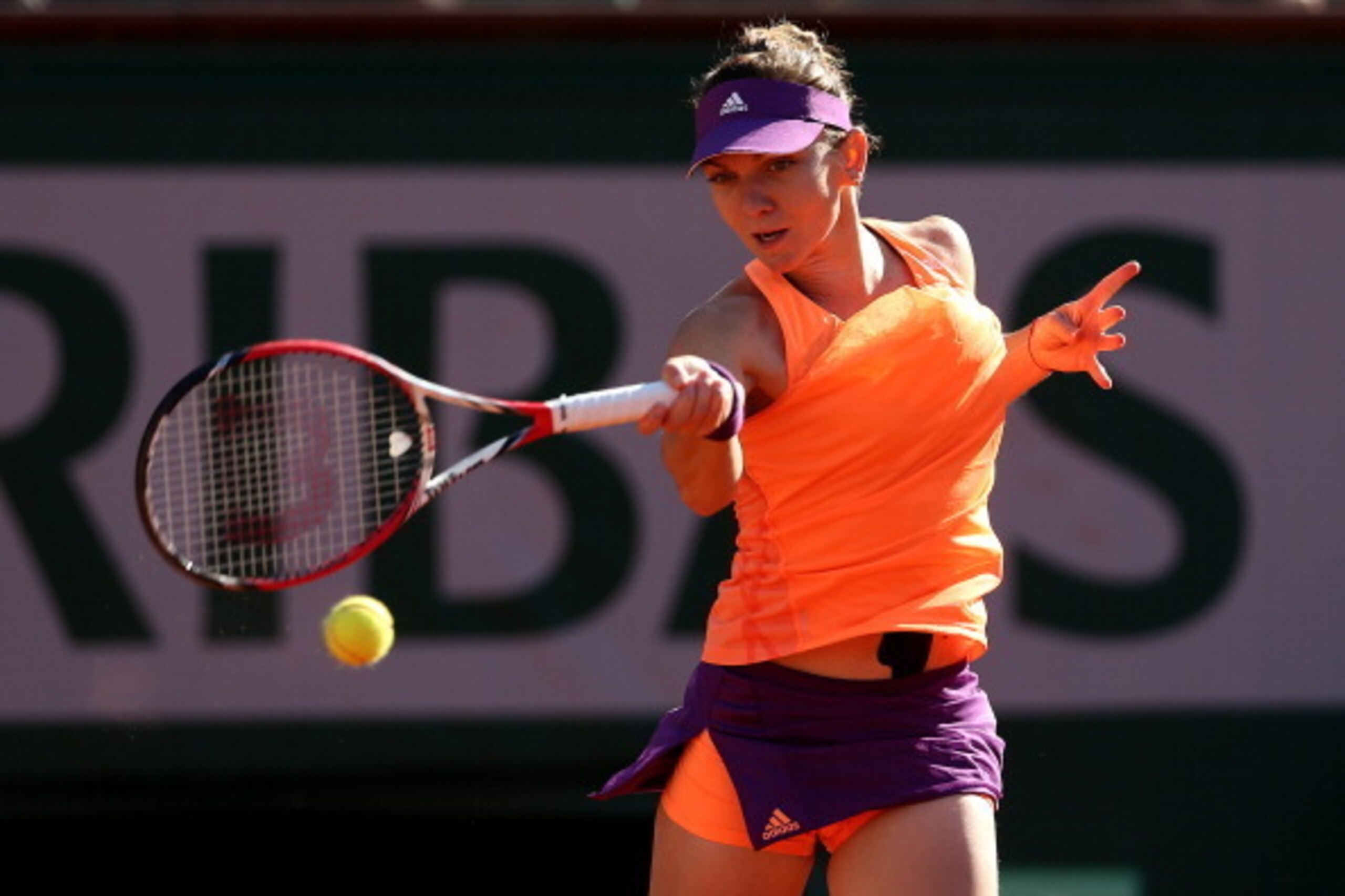 PARIS, FRANCE - JUNE 05: Simona Halep of Romania returns a shot during her women's singles match against Andrea Petkovic of Germany on day twelve of the French Open at Roland Garros on June 5, 2014 in Paris, France. (Photo by Matthew Stockman/Getty Imag PARIS, FRANCE - JUNE 05: Simona Halep of Romania returns a shot during her women's singles match against Andrea Petkovic of Germany on day twelve of the French Open at Roland Garros on June 5, 2014 in Paris, France. (Photo by Matthew Stockman/Getty Imag