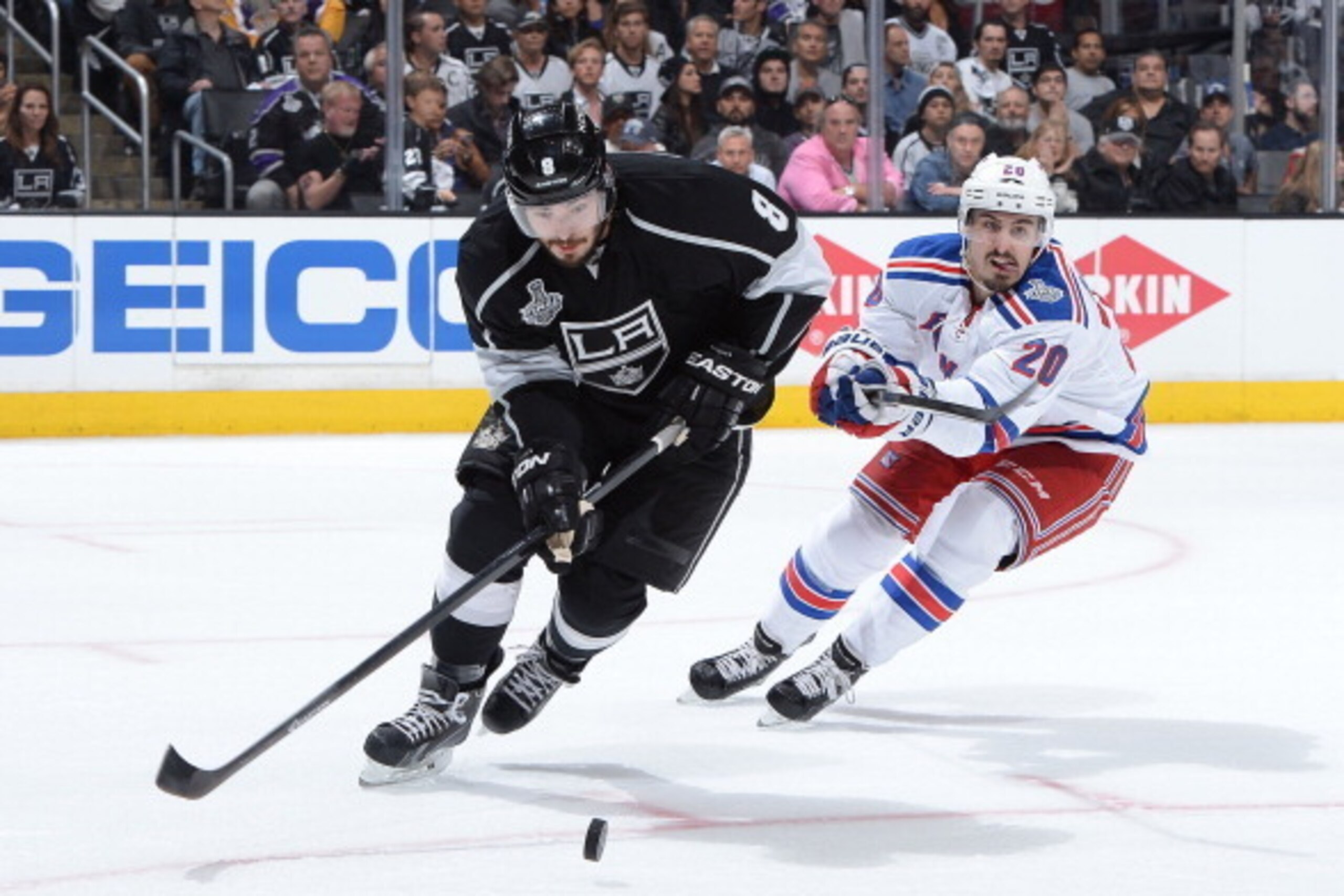 LOS ANGELES, CA - JUNE 4:  Drew Doughty #8 of the Los Angeles Kings skates with the puck against Chris Kreider #20 of the New York Rangers in Game One of the Stanley Cup Final during the 2014 Stanley Cup Playoffs at Staples Center on June 4, 2014 in Los A