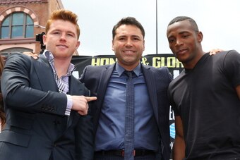 LOS ANGELES, CA - MAY 06:  Boxers Canelo Alvarez (L) and Erislandy Lara (R) and Oscar De La Hoya (C), president of Golden Boy Promotions, pose onstage during the press tour for Canelo Alvarez v Erislandy Lara on May 6, 2014 in Los Angeles, California.  (P
