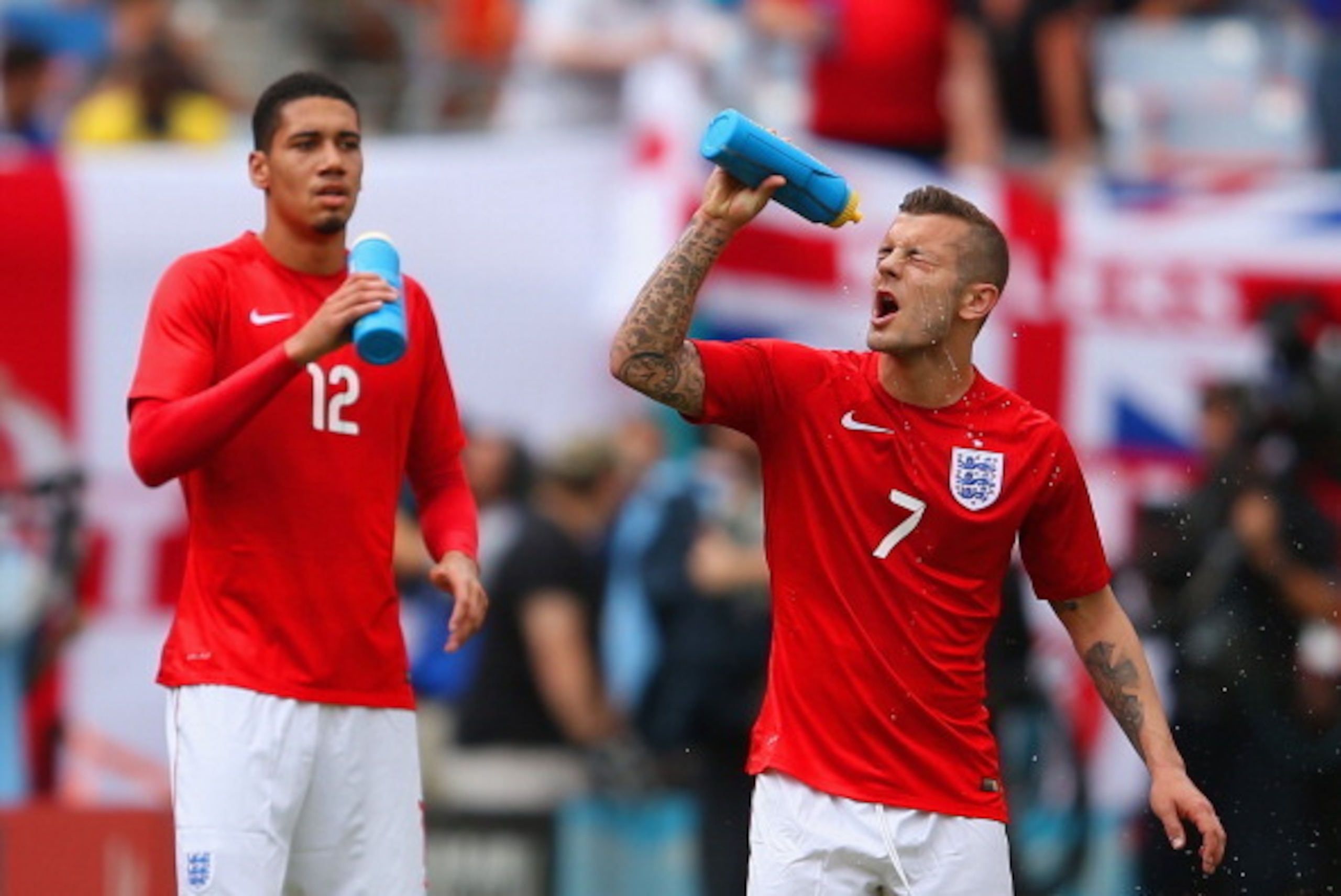 MIAMI GARDENS, FL - JUNE 04: Chris Smalling of England and Jack Wilshere of England take a drink during the International friendly match between England and Ecuador at Sun Life Stadium on June 4, 2014 in Miami Gardens, Florida.  (Photo by Richard Heathcot