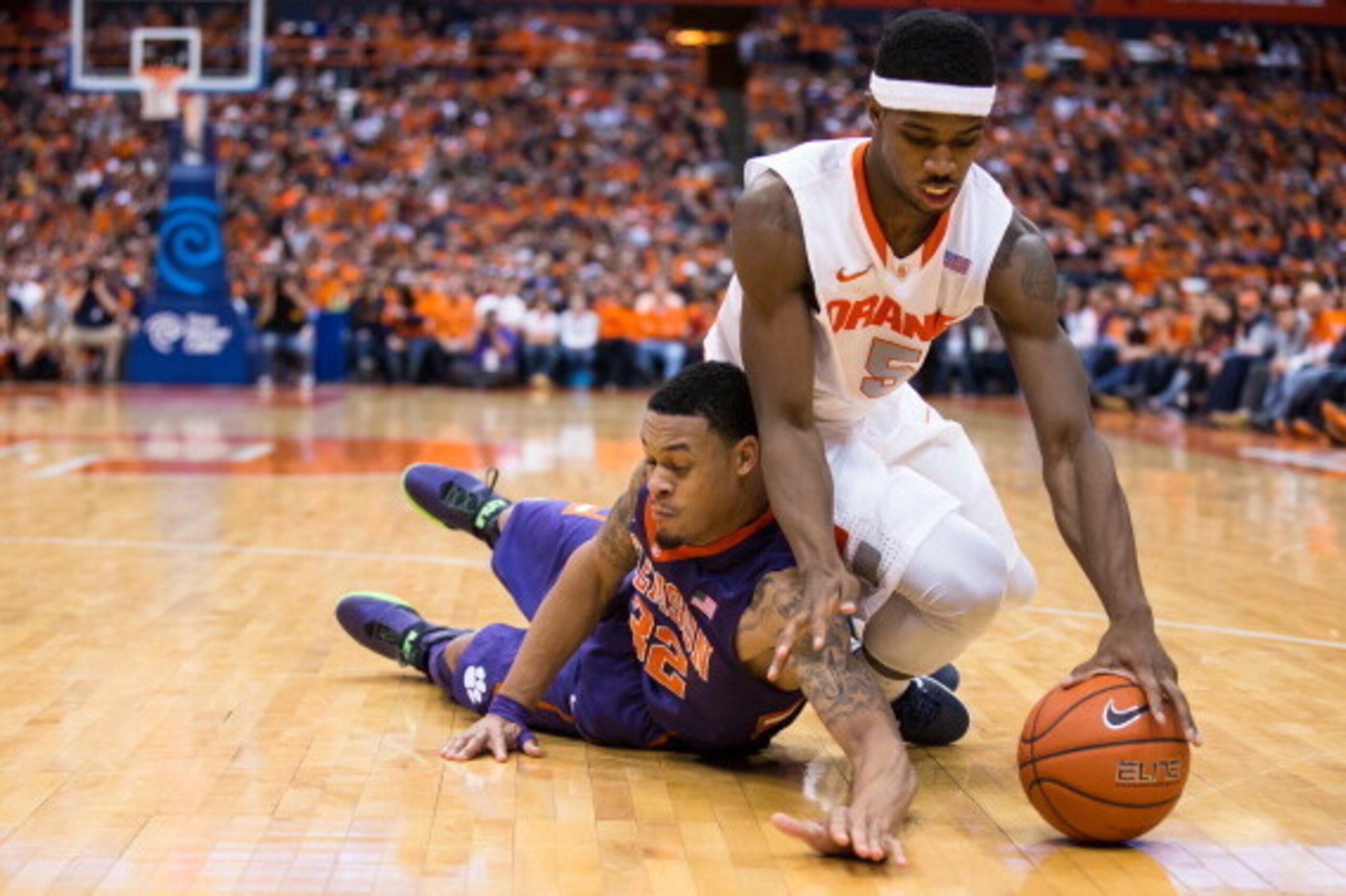 SYRACUSE, NY - FEBRUARY 9: K.J. McDaniels #32 of the Clemson Tigers and C.J. Fair #5 of the Syracuse Orange battle for a loose ball during the second half on February 9, 2014 at The Carrier Dome in Syracuse, New York. Syracuse defeats Clemson 57-44. (Ph SYRACUSE, NY - FEBRUARY 9: K.J. McDaniels #32 of the Clemson Tigers and C.J. Fair #5 of the Syracuse Orange battle for a loose ball during the second half on February 9, 2014 at The Carrier Dome in Syracuse, New York. Syracuse defeats Clemson 57-44. (Ph
