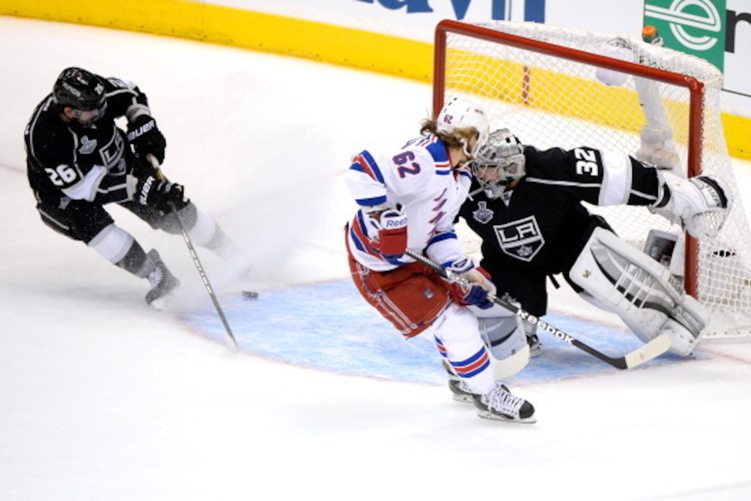 LOS ANGELES, CA - JUNE 04:  Carl Hagelin #62 of the New York Rangers scores a goal that bounced off Slava Voynov #26 of the Los Angeles Kings in the first period during Game One of the 2014 NHL Stanley Cup Final at the Staples Center on June 4, 2014 in Lo