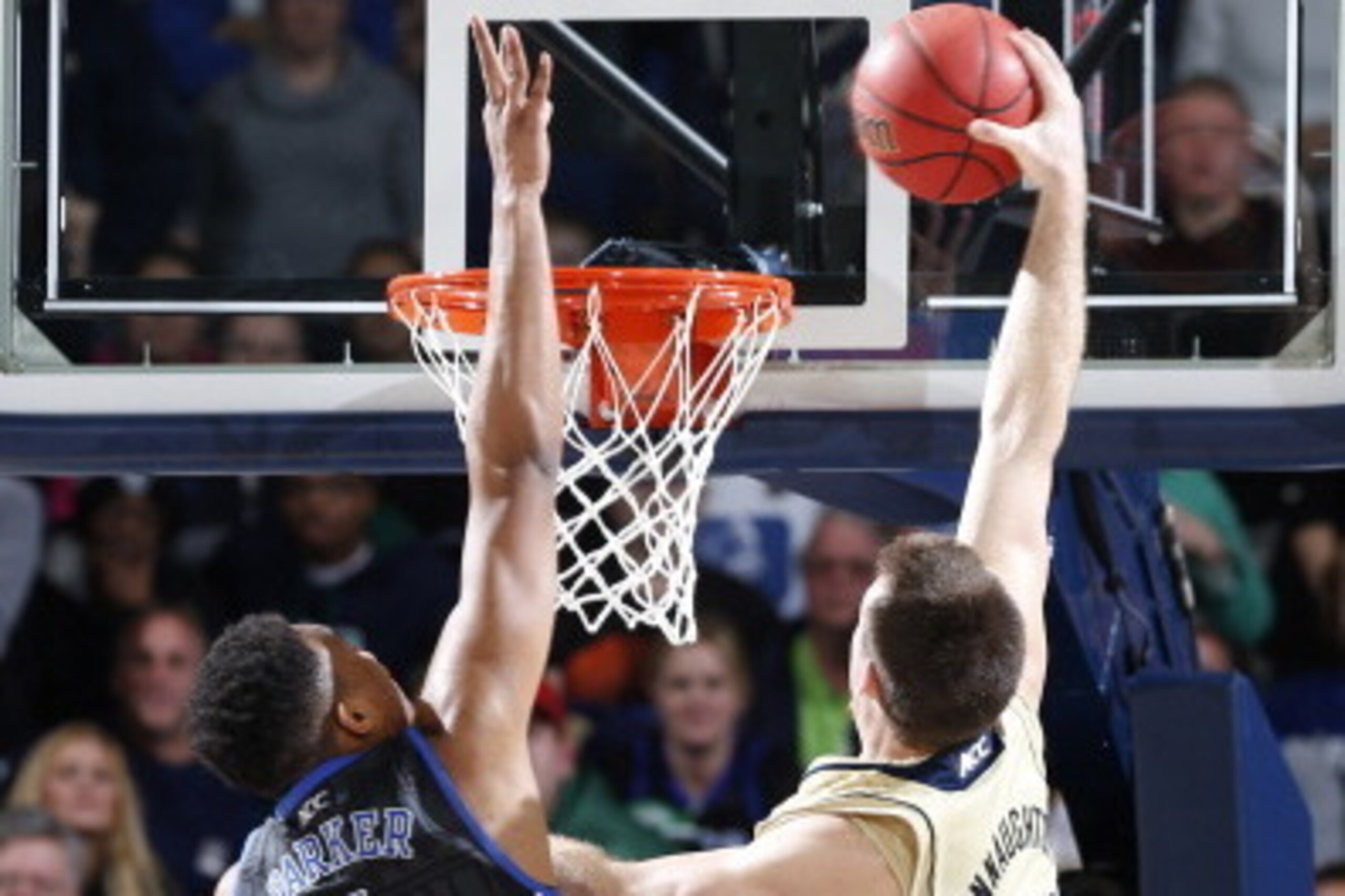SOUTH BEND, IN - JANUARY 4: Pat Connaughton #24 of the Notre Dame Fighting Irish dunks the ball against Jabari Parker #1 of the Duke Blue Devils during the game at Purcell Pavilion at the Joyce Center on January 4, 2014 in South Bend, Indiana. Notre Dame 