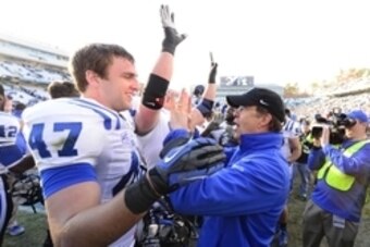 Nov 30, 2013; Chapel Hill, NC, USA;  Duke Blue Devils head coach David Cutcliff with linebacker David Helton (47) after the game. The Duke Blue Devils defeated the North Carolina Tar Heels 27-25 at Kenan Memorial Stadium. Mandatory Credit: Bob Donnan-USA