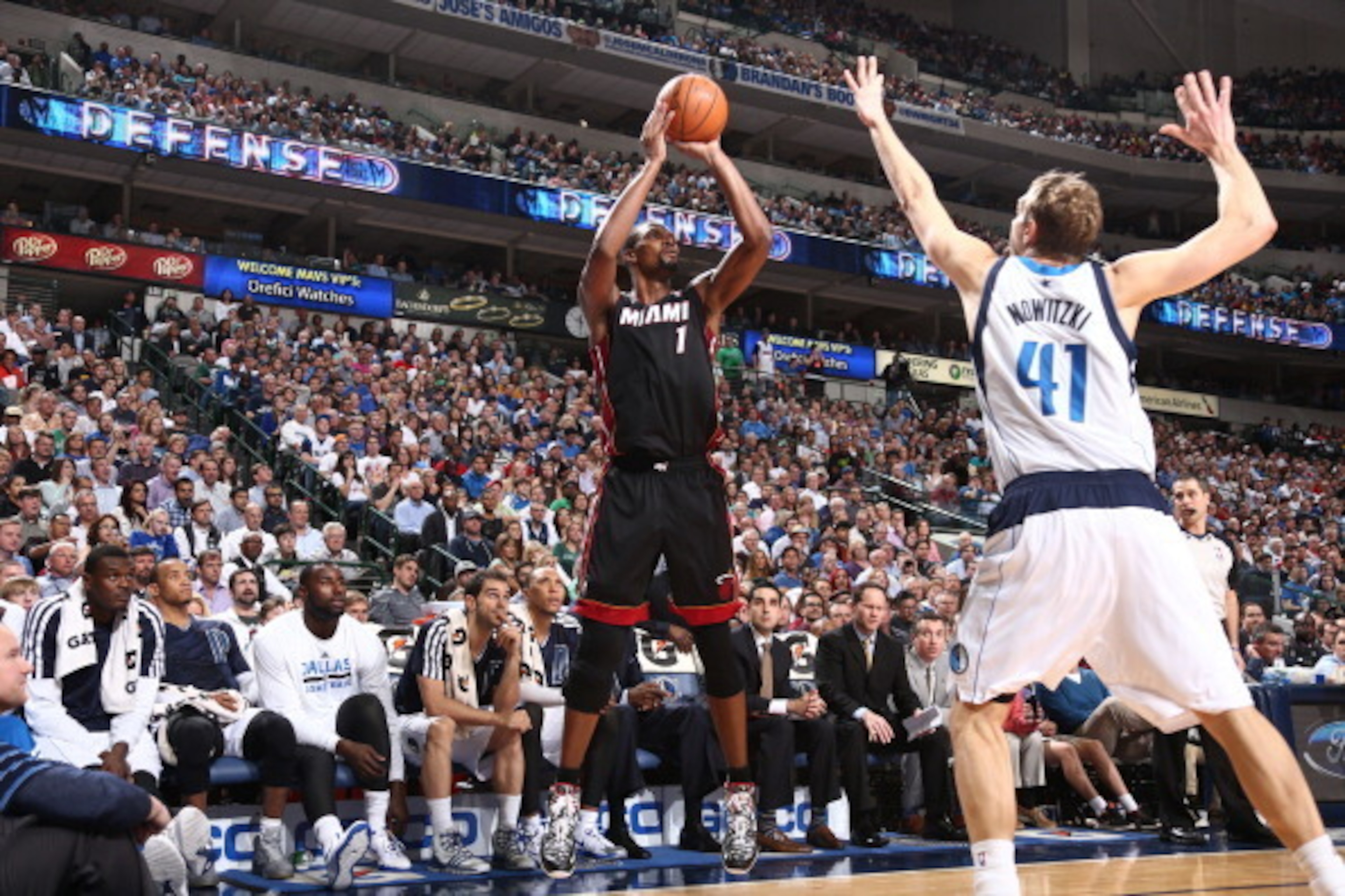 DALLAS, TX - FEBRUARY 18: Chris Bosh #1 of the Miami Heat shoots against Dirk Nowitzki #41 of the Dallas Mavericks during a game at American Airlines Center on February 18, 2014 in Dallas, Texas. NOTE TO USER: User expressly acknowledges and agrees that, DALLAS, TX - FEBRUARY 18: Chris Bosh #1 of the Miami Heat shoots against Dirk Nowitzki #41 of the Dallas Mavericks during a game at American Airlines Center on February 18, 2014 in Dallas, Texas. NOTE TO USER: User expressly acknowledges and agrees that,
