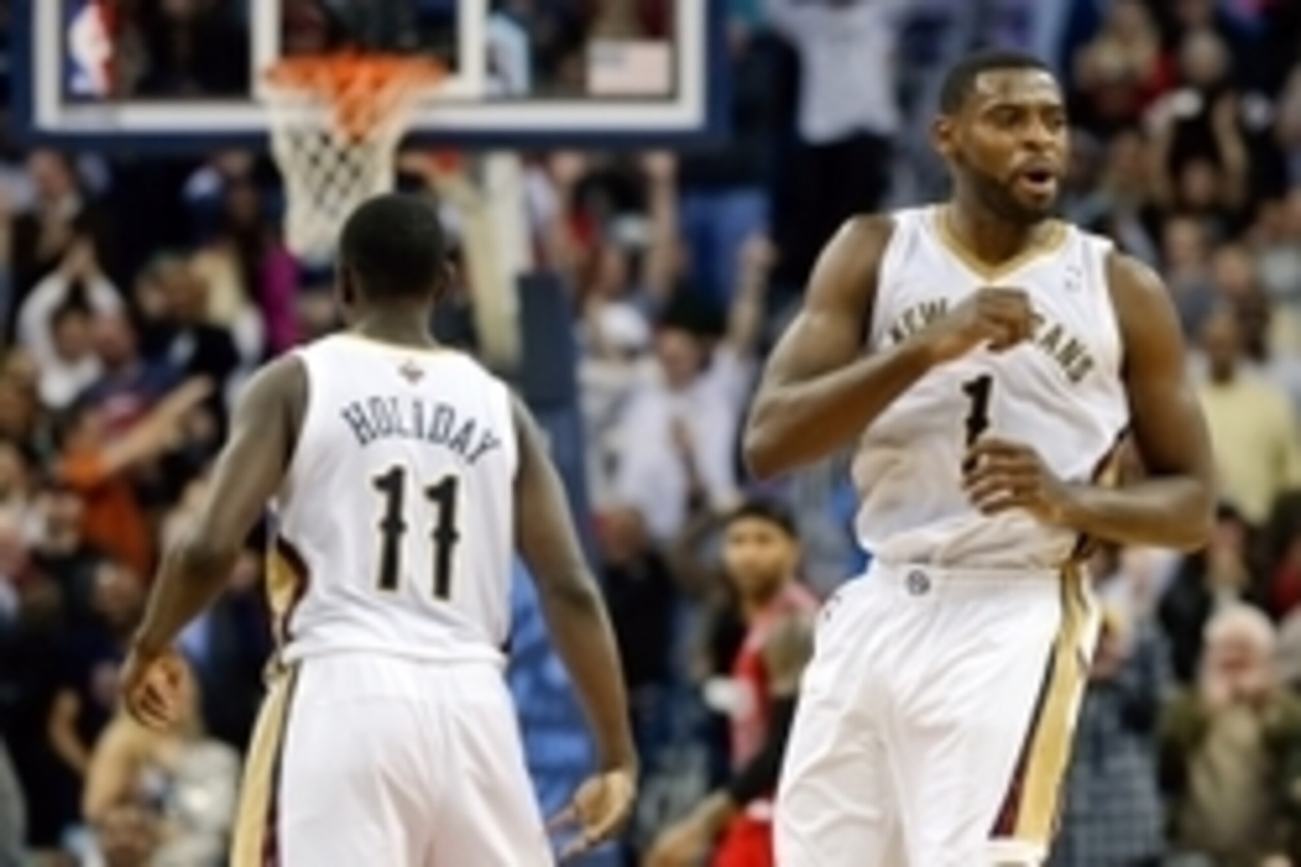 Dec 30, 2013; New Orleans, LA, USA; New Orleans Pelicans point guard Tyreke Evans (1) celebrates with teammate point guard Jrue Holiday (11) after hitting a shot to take the lead with 1.2 seconds remaining in the fourth quarter of a game against the Portl