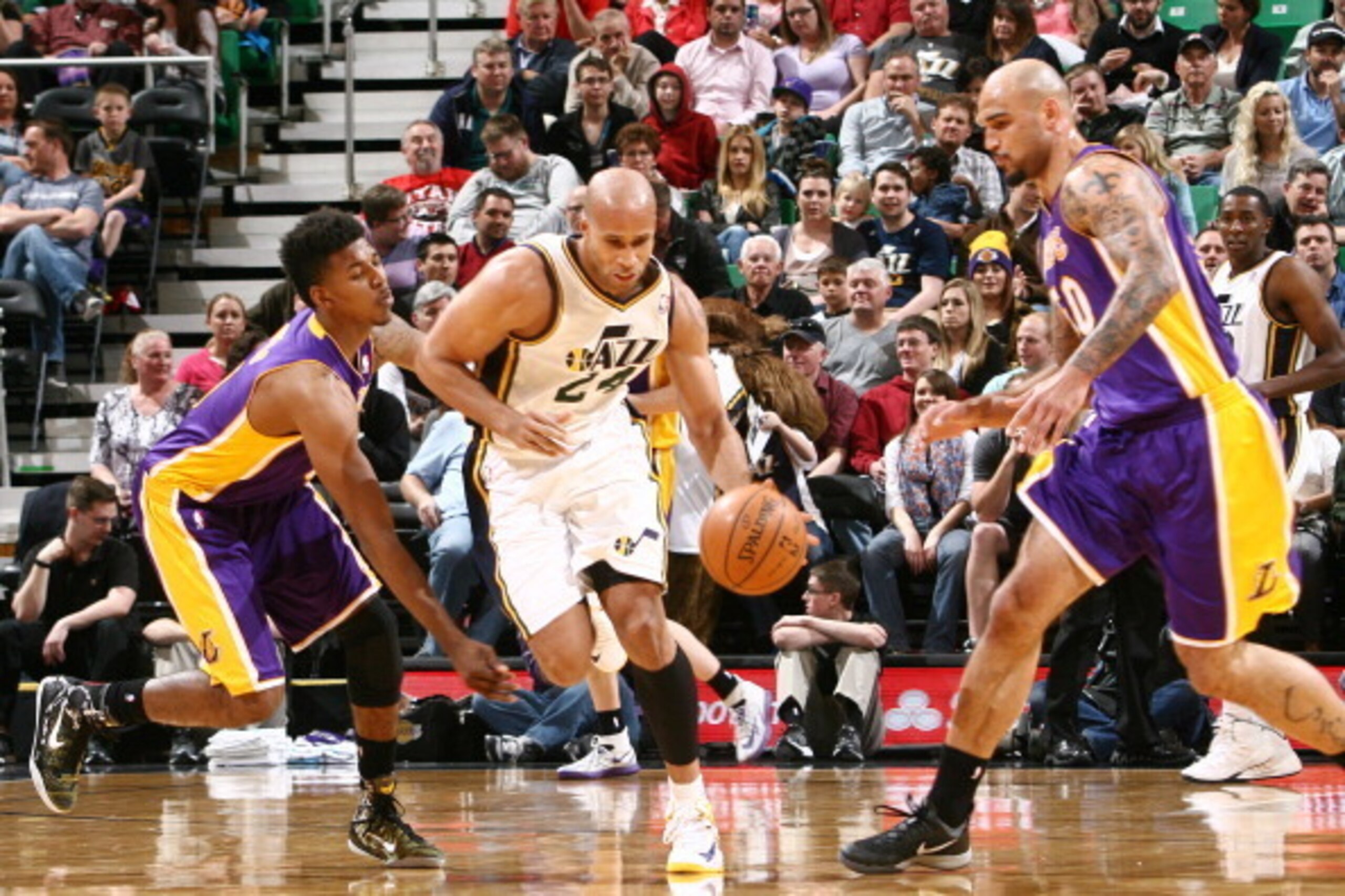 SALT LAKE CITY, UT - APRIL 14: Richard Jefferson #24 of the Utah Jazz dribbles by Nick Young #0 and Robert Sacre #50 of the Los Angeles Lakers at EnergySolutions Arena on April 14, 2014 in Salt Lake City, Utah. NOTE TO USER: User expressly acknowledges an