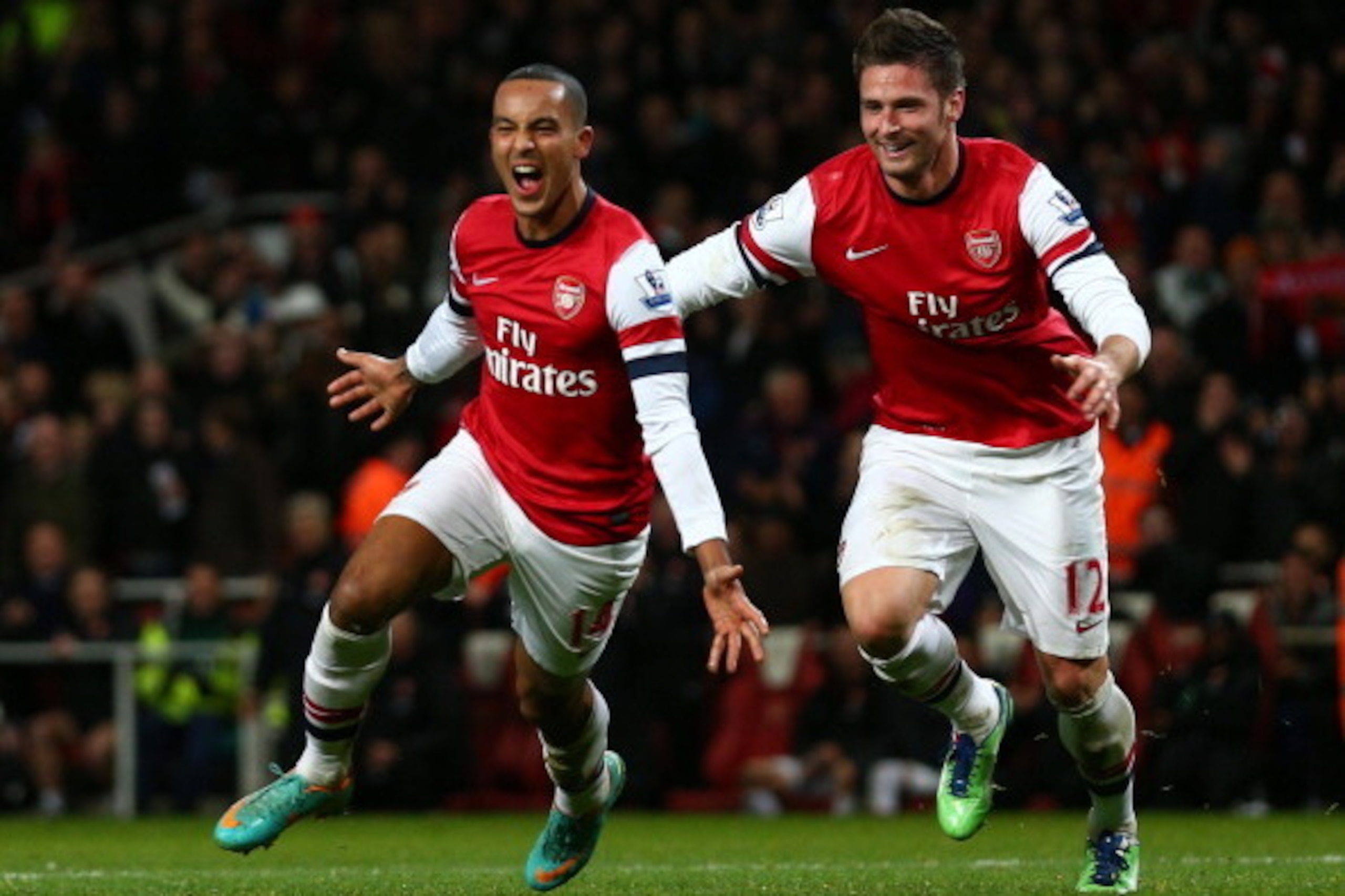 LONDON, ENGLAND - DECEMBER 29: Theo Walcott of Arsenal celebrates scoring his hat trick and Arsenal's seventh goal with Olivier Giroud of Arsenal during the Barclays Premier League match between Arsenal and Newcastle United at the Emirates Stadium on Dece