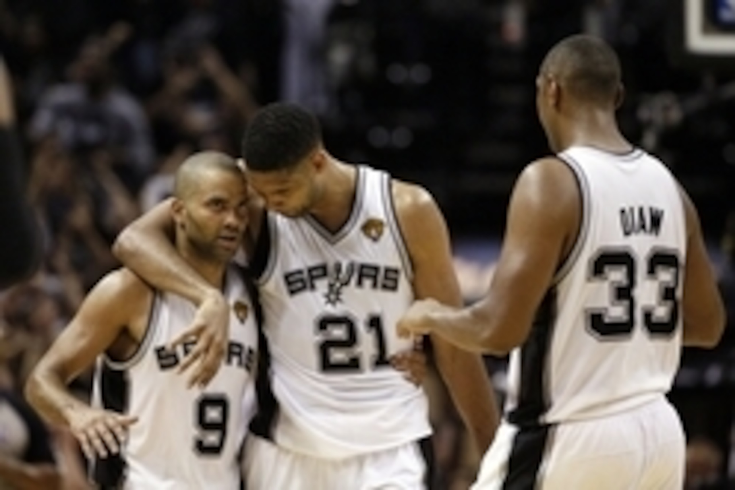 Jun 5, 2014; San Antonio, TX, USA; San Antonio Spurs guard Tony Parker (9) celebrates with San Antonio Spurs forward Tim Duncan (21) and forward Boris Diaw (33) during the fourth quarter in game one of the 2014 NBA Finals at AT&T Center. Mandatory Credit:
