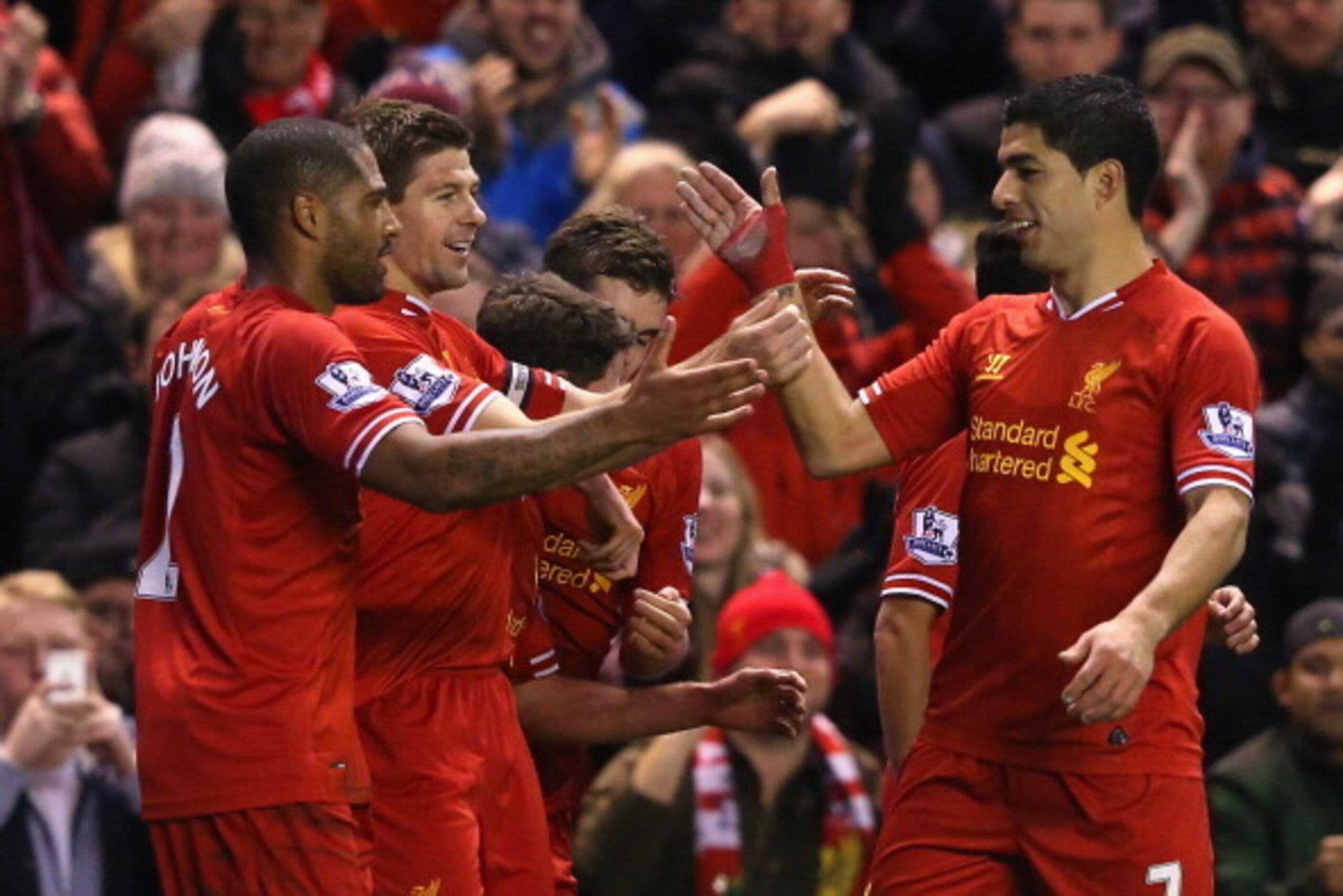 LIVERPOOL, ENGLAND - MARCH 26:  Steven Gerrard of Liverpool celebrates scoring the first goal with team-mate Luis Suarez (R) during the Barclays Premier League match between Liverpool and Sunderland at Anfield on March 26, 2014 in Liverpool, England.  (Ph