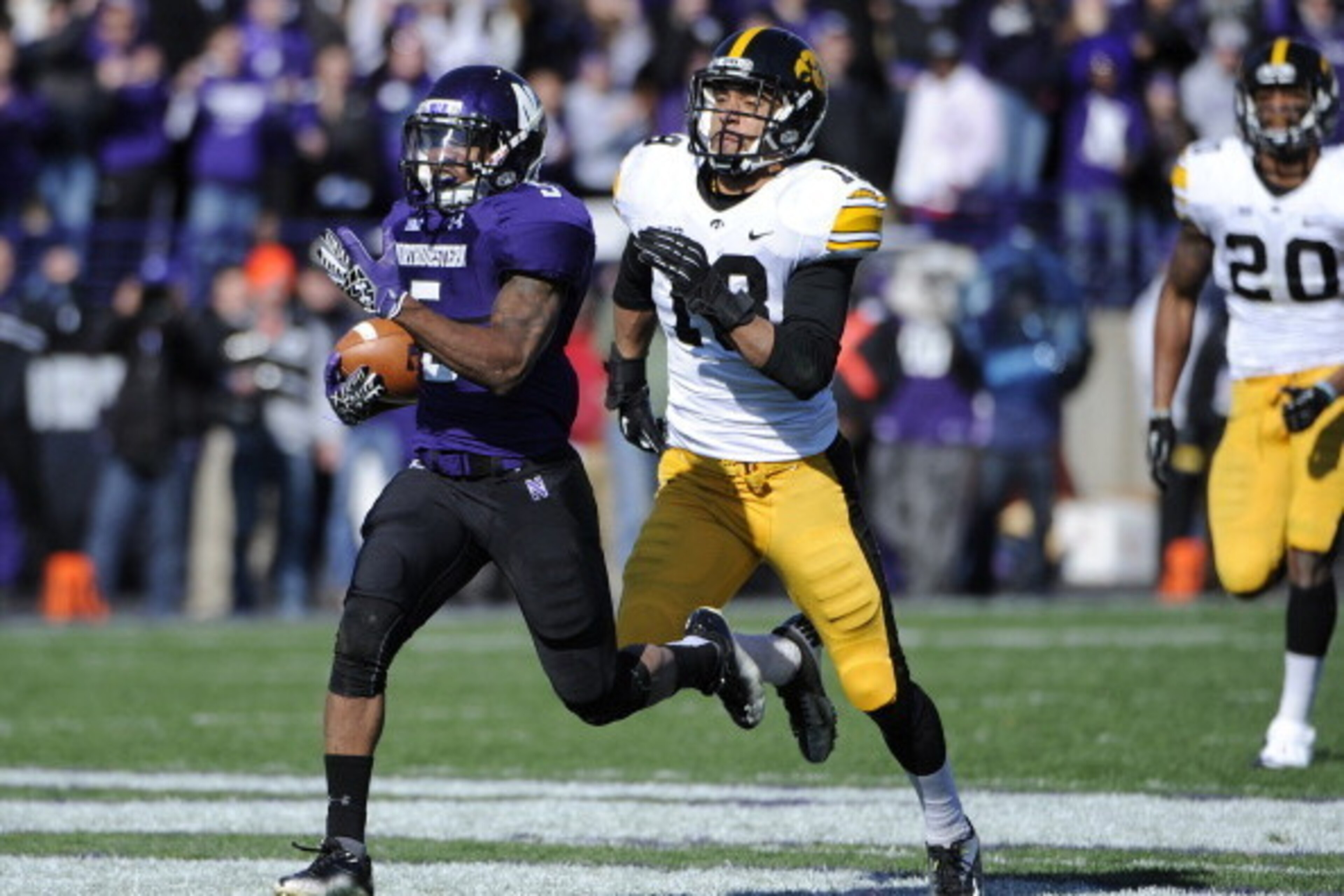 EVANSTON, IL - OCTOBER 27: Venric Mark #5 of the Northwestern Wildcats runs as Micah Hyde #18 of the Iowa Hawkeyes chases him on October 27, 2012 at Ryan Field in Evanston, Illinois.  (Photo by David Banks/Getty Images)