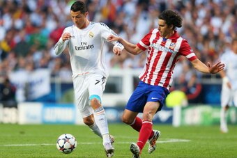 LISBON, PORTUGAL - MAY 24:  Cristiano Ronaldo of Real Madrid is closed down by Tiago of Club Atletico de Madrid during the UEFA Champions League Final between Real Madrid and Atletico de Madrid at Estadio da Luz on May 24, 2014 in Lisbon, Portugal.  (Phot