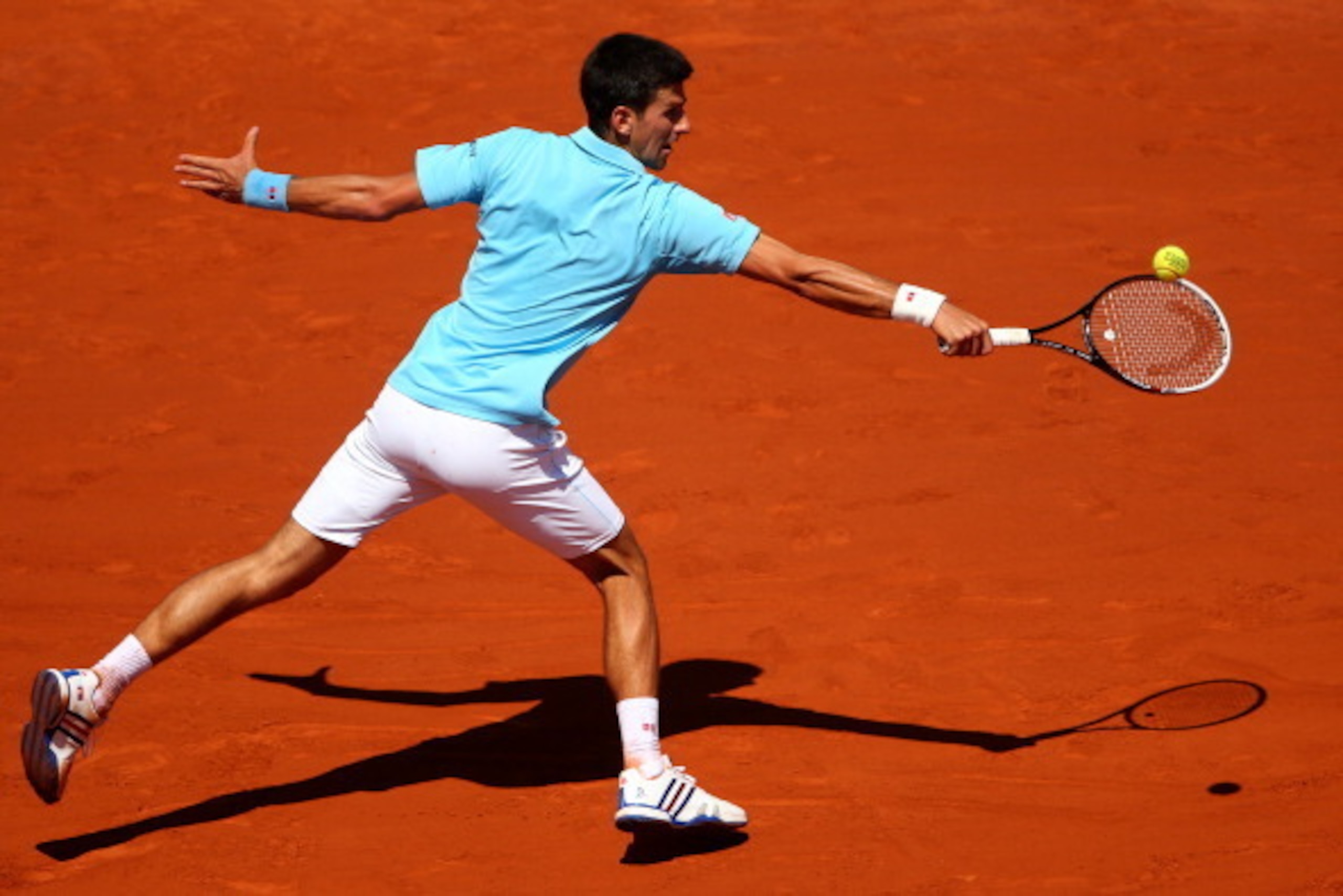 PARIS, FRANCE - JUNE 06:  Novak Djokovic of Serbia returns a shot during his men's singles semi-final match against Ernests Gulbis of Latvia on day thirteen of the French Open at Roland Garros on June 6, 2014 in Paris, France.  (Photo by Clive Brunskill/G