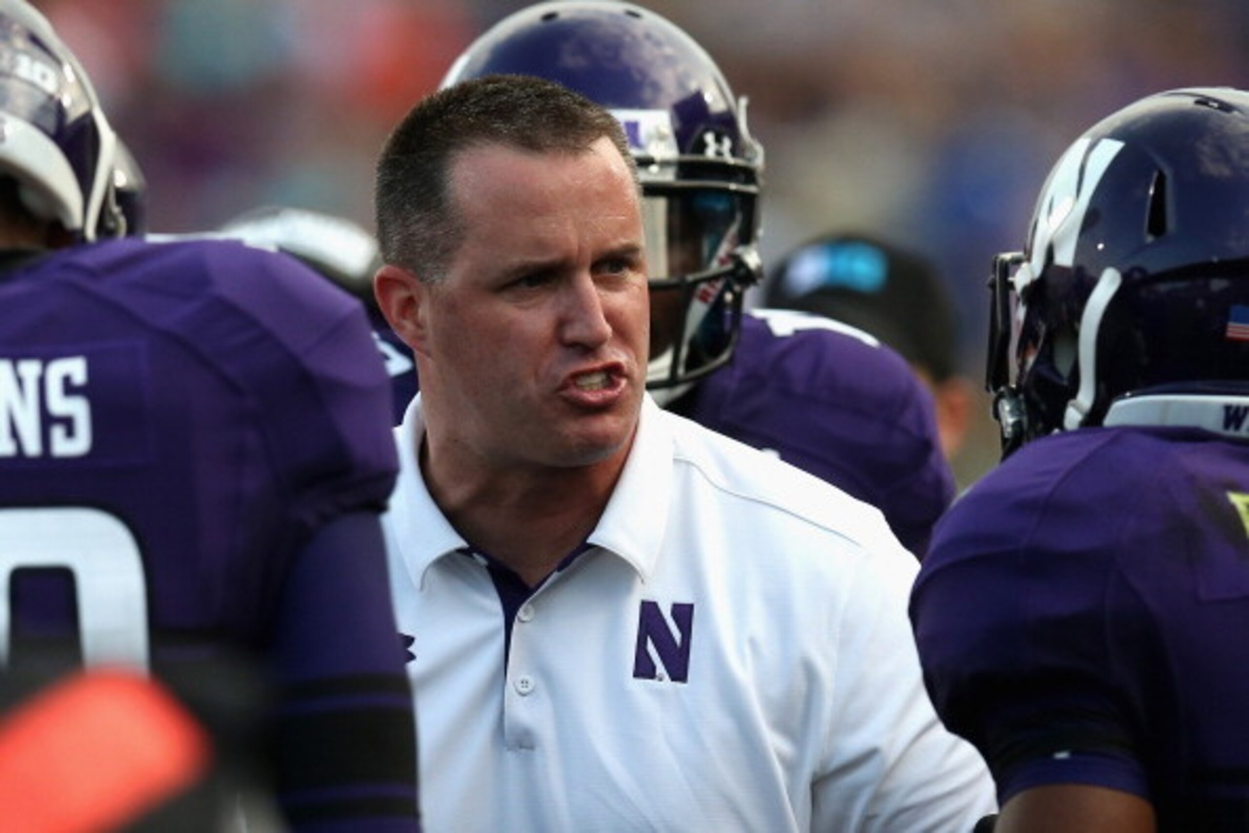 EVANSTON, IL - SEPTEMBER 07:  Head coach Pat Fitzgerald of the Northwestern Wildcats talks to his players as they leave the field against the Syracuse Orange at Ryan Field on September 7, 2013 in Evanston, Illinois. Northwestern defeated Syracuse 48-20.  
