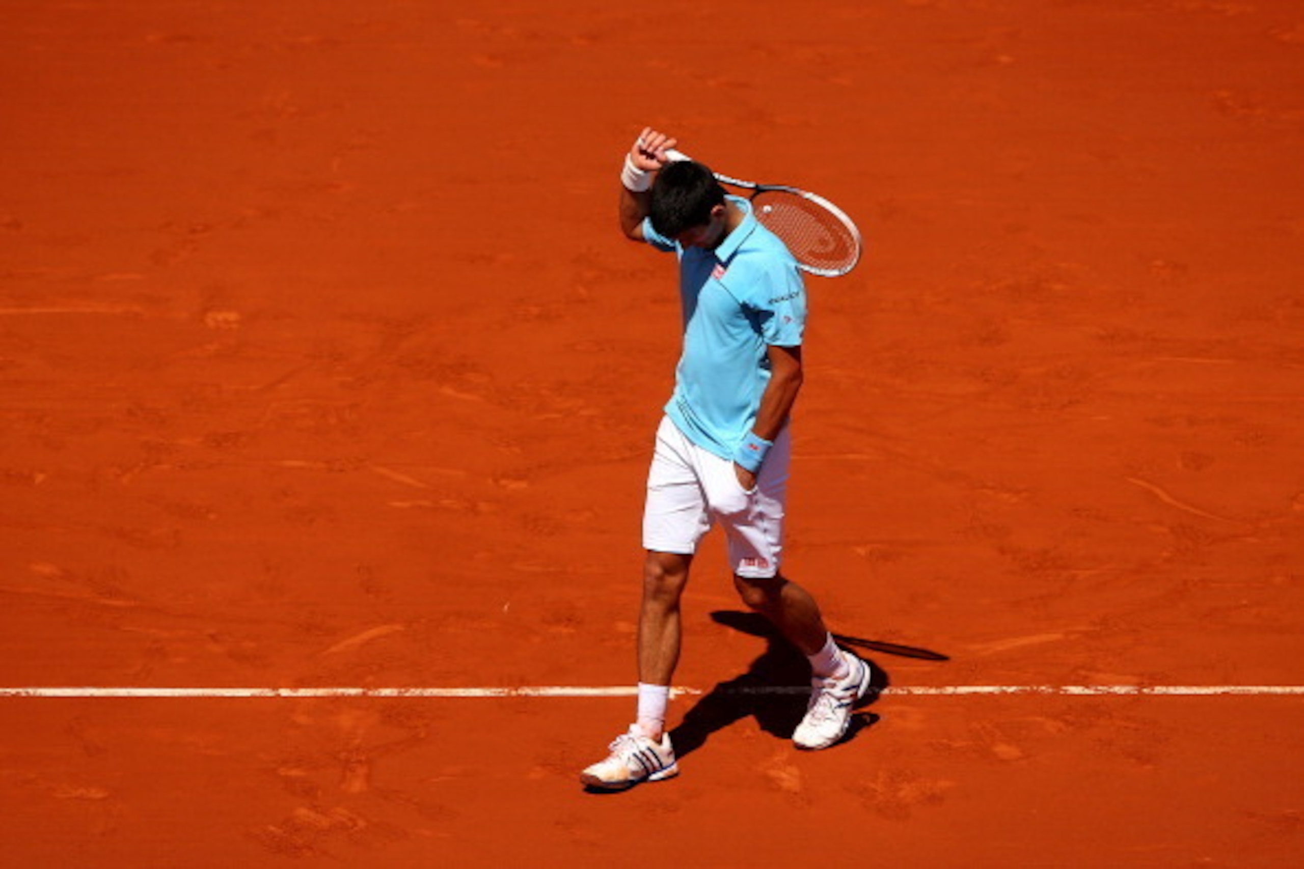 PARIS, FRANCE - JUNE 06: Novak Djokovic of Serbia reacts during his men's singles semi-final match against Ernests Gulbis of Latvia on day thirteen of the French Open at Roland Garros on June 6, 2014 in Paris, France. (Photo by Clive Brunskill/Getty Ima PARIS, FRANCE - JUNE 06: Novak Djokovic of Serbia reacts during his men's singles semi-final match against Ernests Gulbis of Latvia on day thirteen of the French Open at Roland Garros on June 6, 2014 in Paris, France. (Photo by Clive Brunskill/Getty Ima