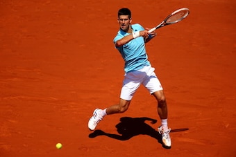 PARIS, FRANCE - JUNE 06:  Novak Djokovic of Serbia returns a shot during his men's singles semi-final match against Ernests Gulbis of Latvia on day thirteen of the French Open at Roland Garros on June 6, 2014 in Paris, France.  (Photo by Clive Brunskill/G