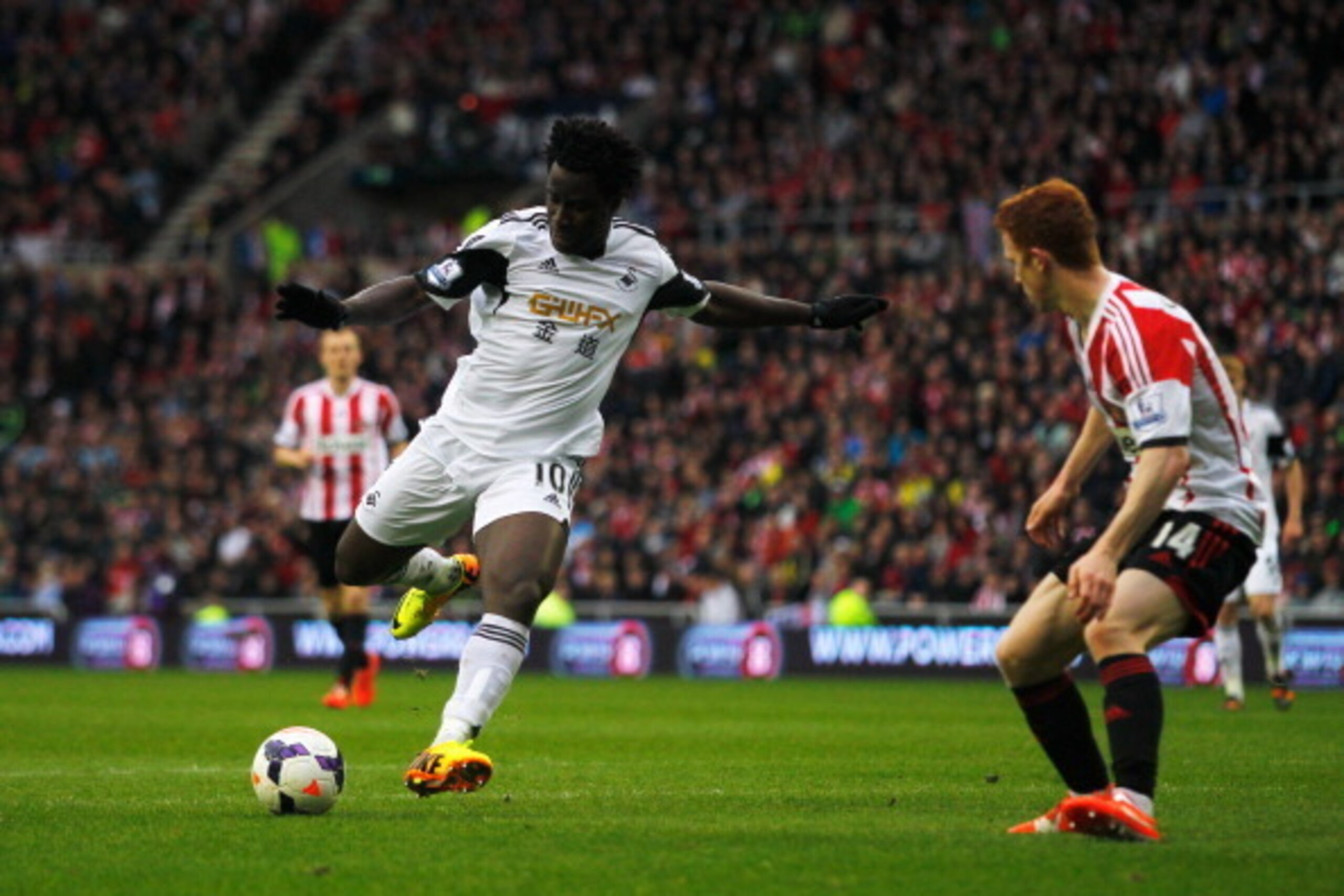 SUNDERLAND, ENGLAND - MAY 11:  Wilfried Bony of Swansea City (L) shoots past Jack Colback of Sunderland as he scores their third goal during the Barclays Premier League match between Sunderland and Swansea City at Stadium of Light on May 11, 2014 in Sunde