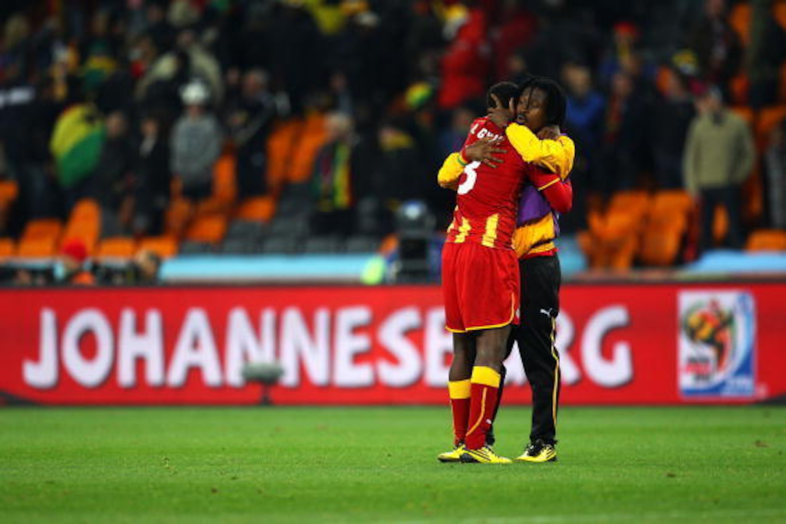 JOHANNESBURG, SOUTH AFRICA - JULY 02:  Asamoah Gyan of Ghana is consoled after his team are knocked out in a penalty shoot out during the 2010 FIFA World Cup South Africa Quarter Final match between Uruguay and Ghana at the Soccer City stadium on July 2, 