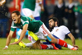 FOXBORO, MA - JUNE 06:  Javier Hernandez #14 of Mexico is fouled by Neto #14 of Portugal in the second half during the international friendly match at Gillette Stadium on June 6, 2014 in Foxboro, Massachusetts.  (Photo by Jared Wickerham/Getty Images)