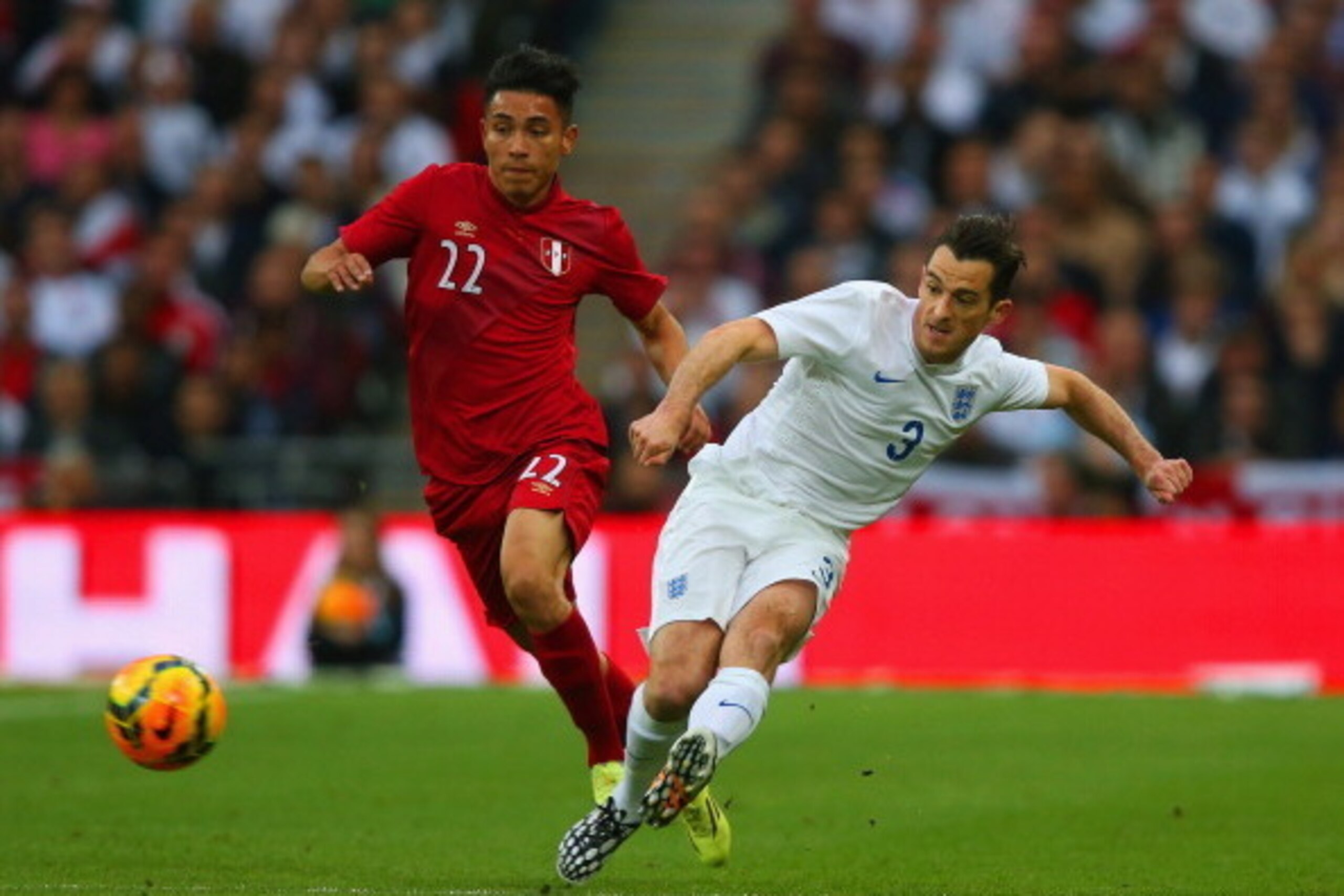 LONDON, ENGLAND - MAY 30:  Jean Deza of Peru and Leighton Baines of England compete for the ball during the international friendly match between England and Peru at Wembley Stadium on May 30, 2014 in London, England.  (Photo by Clive Rose/Getty Images)
