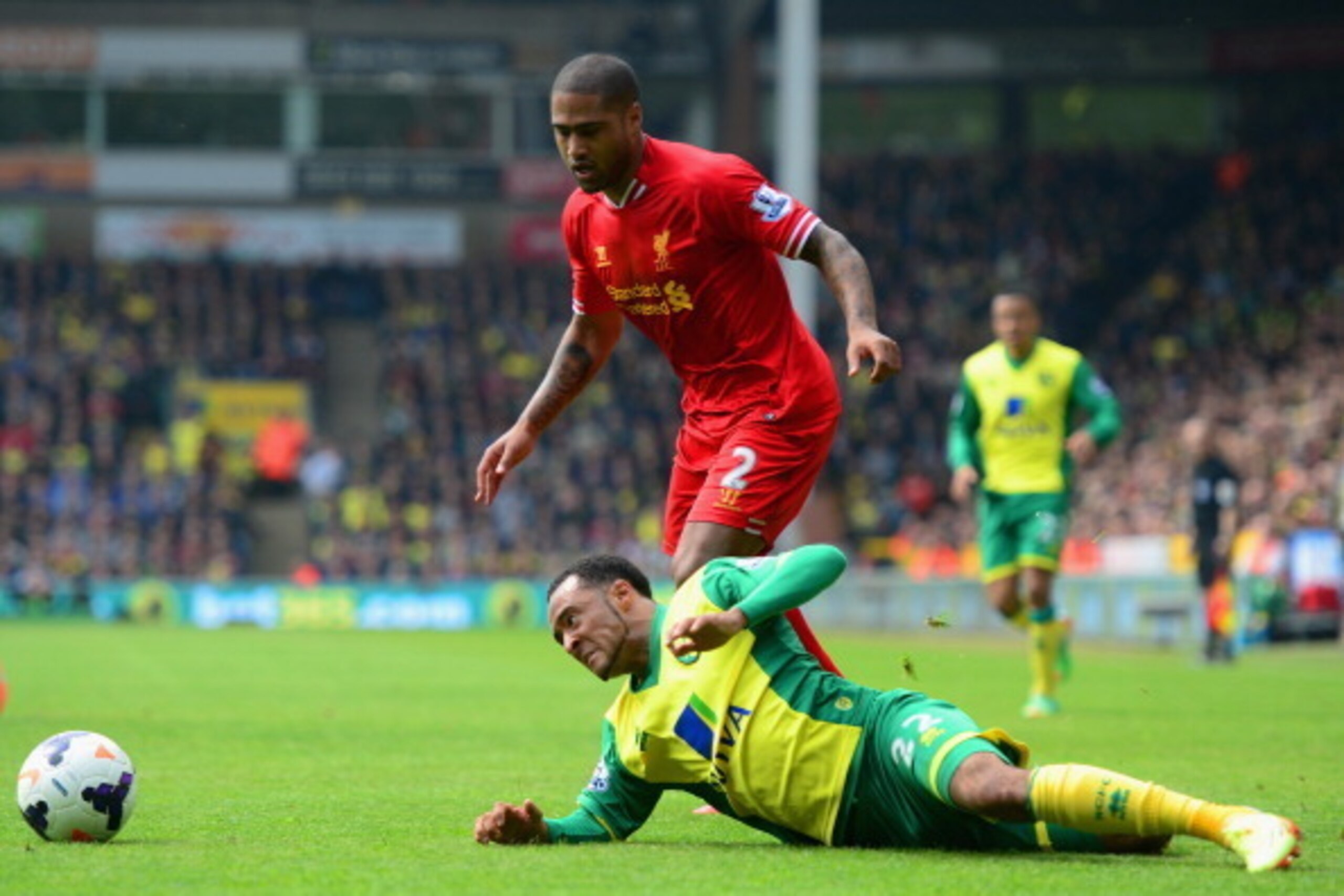 NORWICH, ENGLAND - APRIL 20:  Nathan Redmond of Norwich City clashes with Glen Johnson of Liverpool during the Barclays Premier League match between Norwich City and Liverpool at Carrow Road on April 20, 2014 in Norwich, England.  (Photo by Jamie McDonald