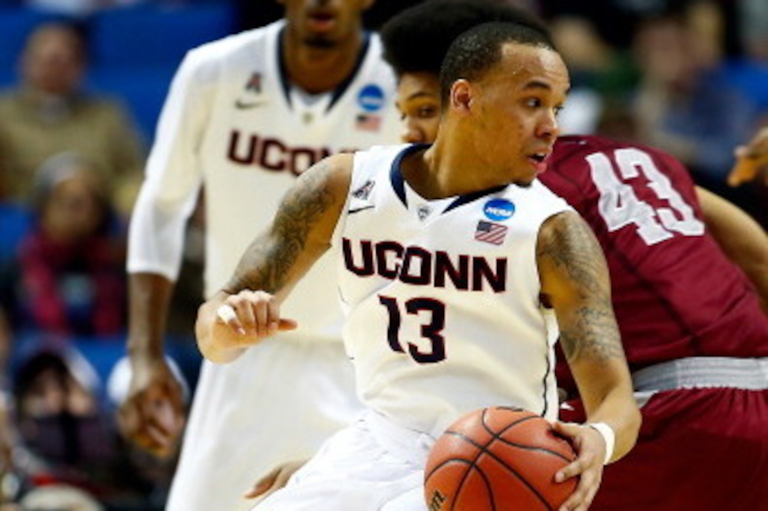 BUFFALO, NY - MARCH 20: Shabazz Napier #13 of the Connecticut Huskies controls the ball as DeAndre Bembry #43 of the Saint Joseph's Hawks defends during the second round of the 2014 NCAA Men's Basketball Tournament at the First Niagara Center on March 20,