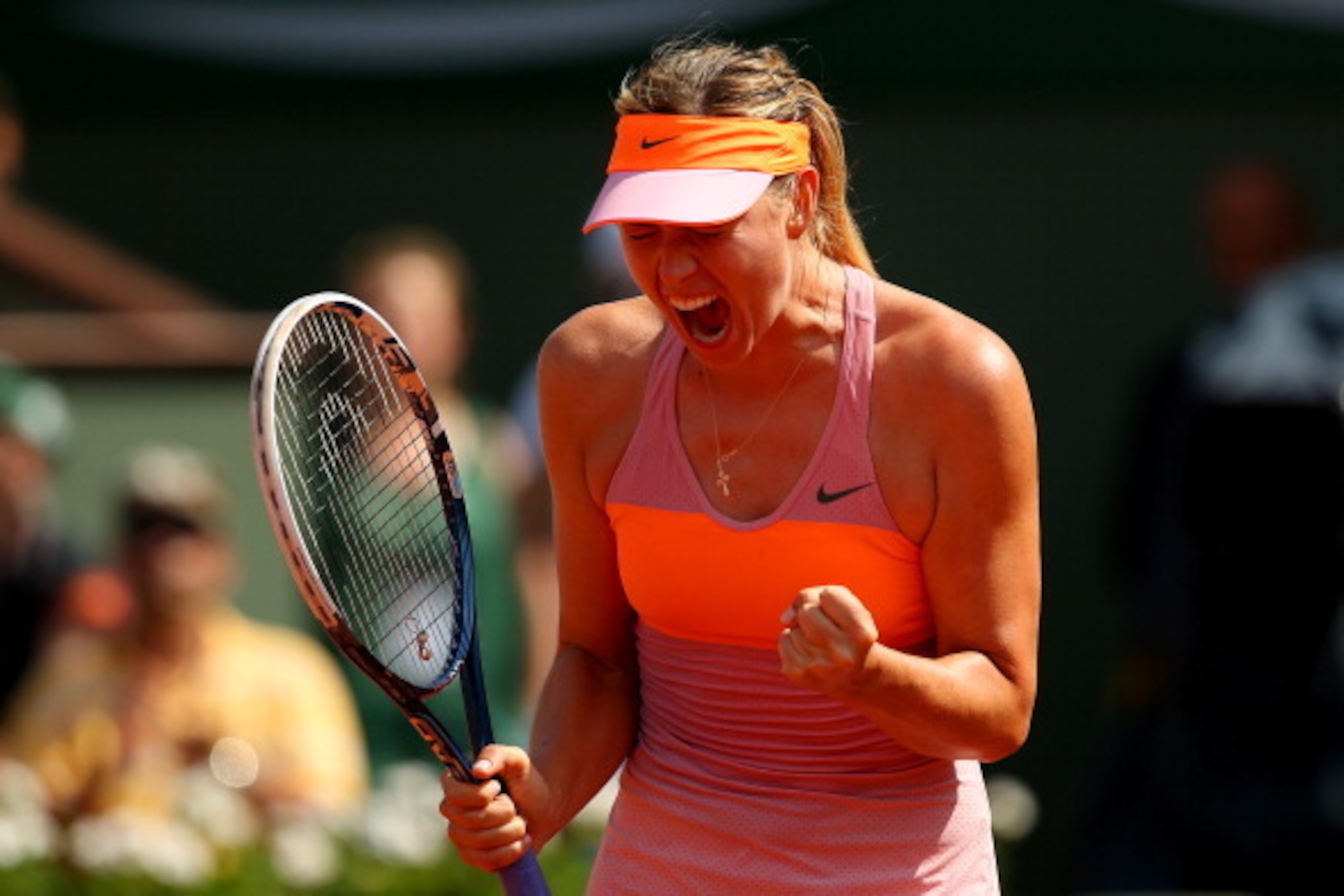 PARIS, FRANCE - JUNE 07:  Maria Sharapova of Russia celebrates a point during her women's singles final match against Simona Halep of Romania on day fourteen of the French Open at Roland Garros on June 7, 2014 in Paris, France.  (Photo by Clive Brunskill/