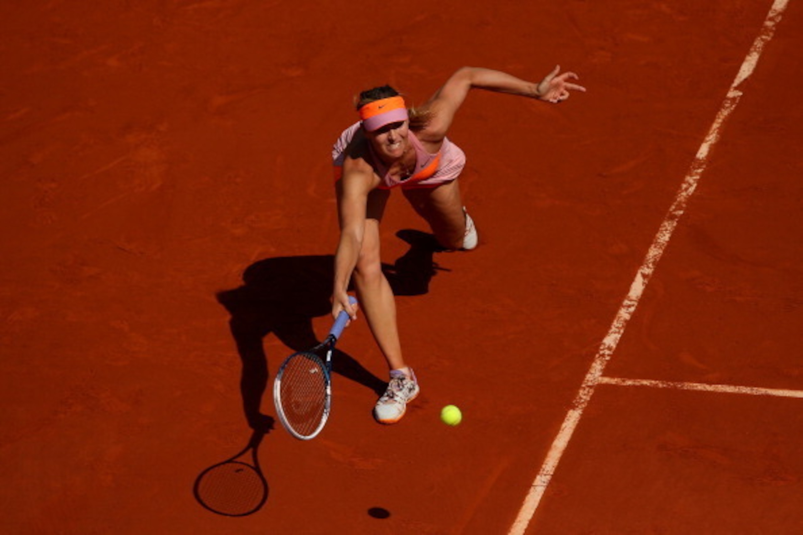 PARIS, FRANCE - JUNE 07:  Maria Sharapova of Russia returns a shot during her women's singles final match against Simona Halep of Romania on day fourteen of the French Open at Roland Garros on June 7, 2014 in Paris, France.  (Photo by Clive Brunskill/Gett