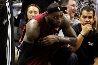 Jun 5, 2014; San Antonio, TX, USA; Miami Heat forward LeBron James (6) kneels on the bench after being injured on the fourth quarter against the San Antonio Spurs in game one of the 2014 NBA Finals at AT&T Center. Mandatory Credit: Soobum Im-USA TODAY Spo