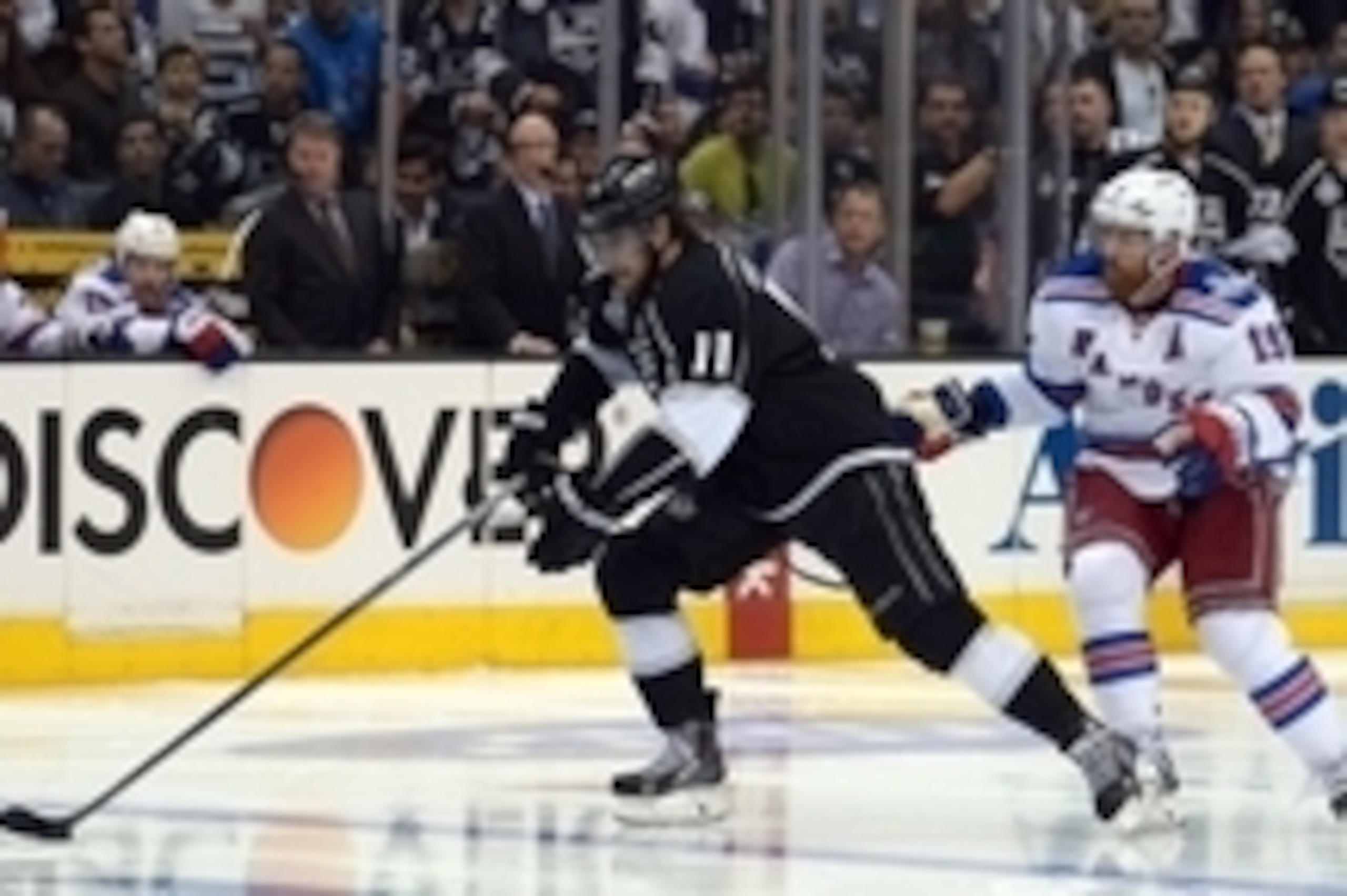 Jun 4, 2014; Los Angeles, CA, USA; Los Angeles Kings center Anze Kopitar (11) skates with the puck past New York Rangers center Brad Richards (19) in the third period during game one of the 2014 Stanley Cup Final at Staples Center. Mandatory Credit: Kirby