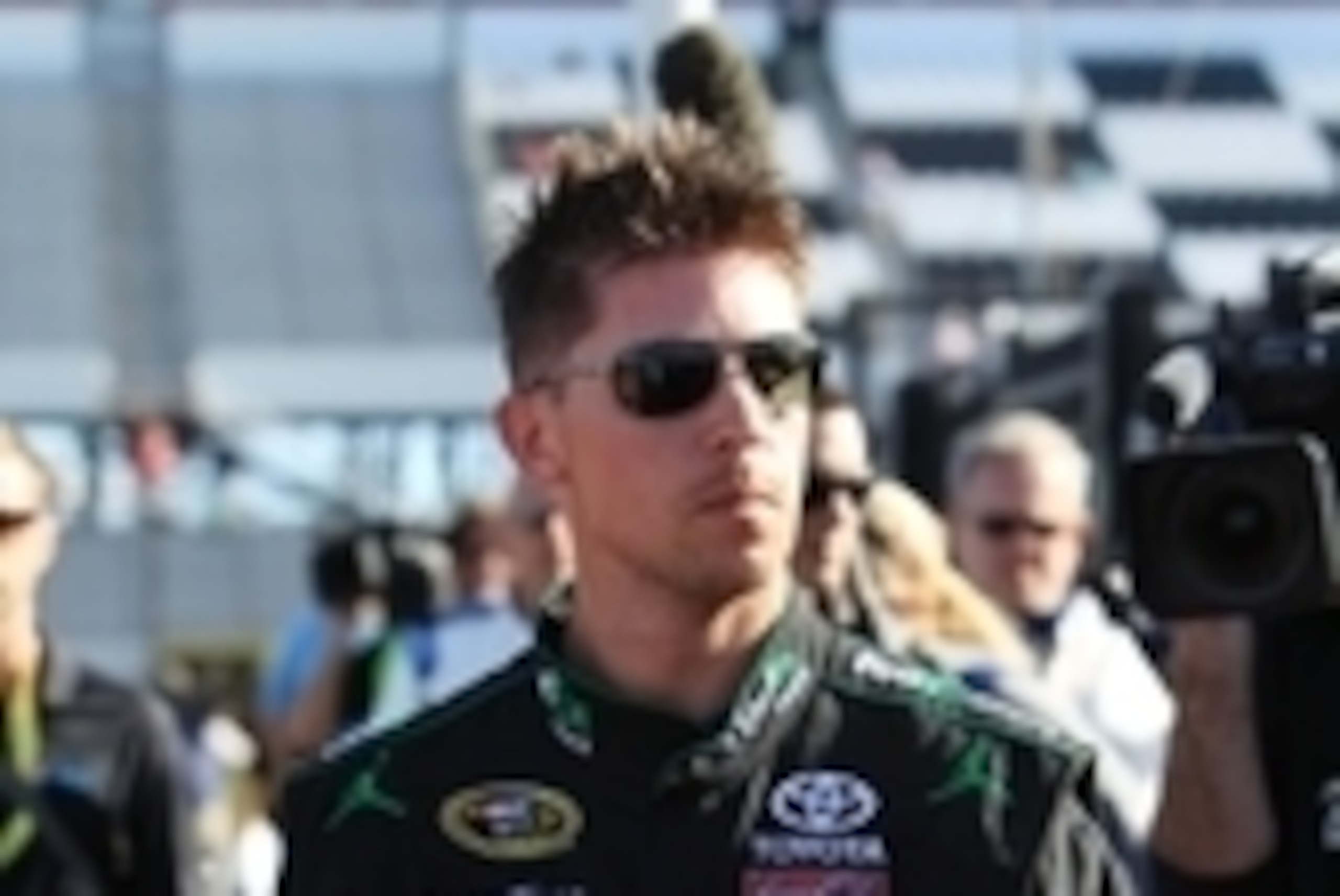 Jun 6, 2014; Long Pond, PA, USA; NASCAR Sprint Cup Series driver Denny Hamlin (11) walks to the garage after winning the pole position during qualifying for the Pocono 400 at Pocono Raceway. Mandatory Credit: Matthew O'Haren-USA TODAY Sports